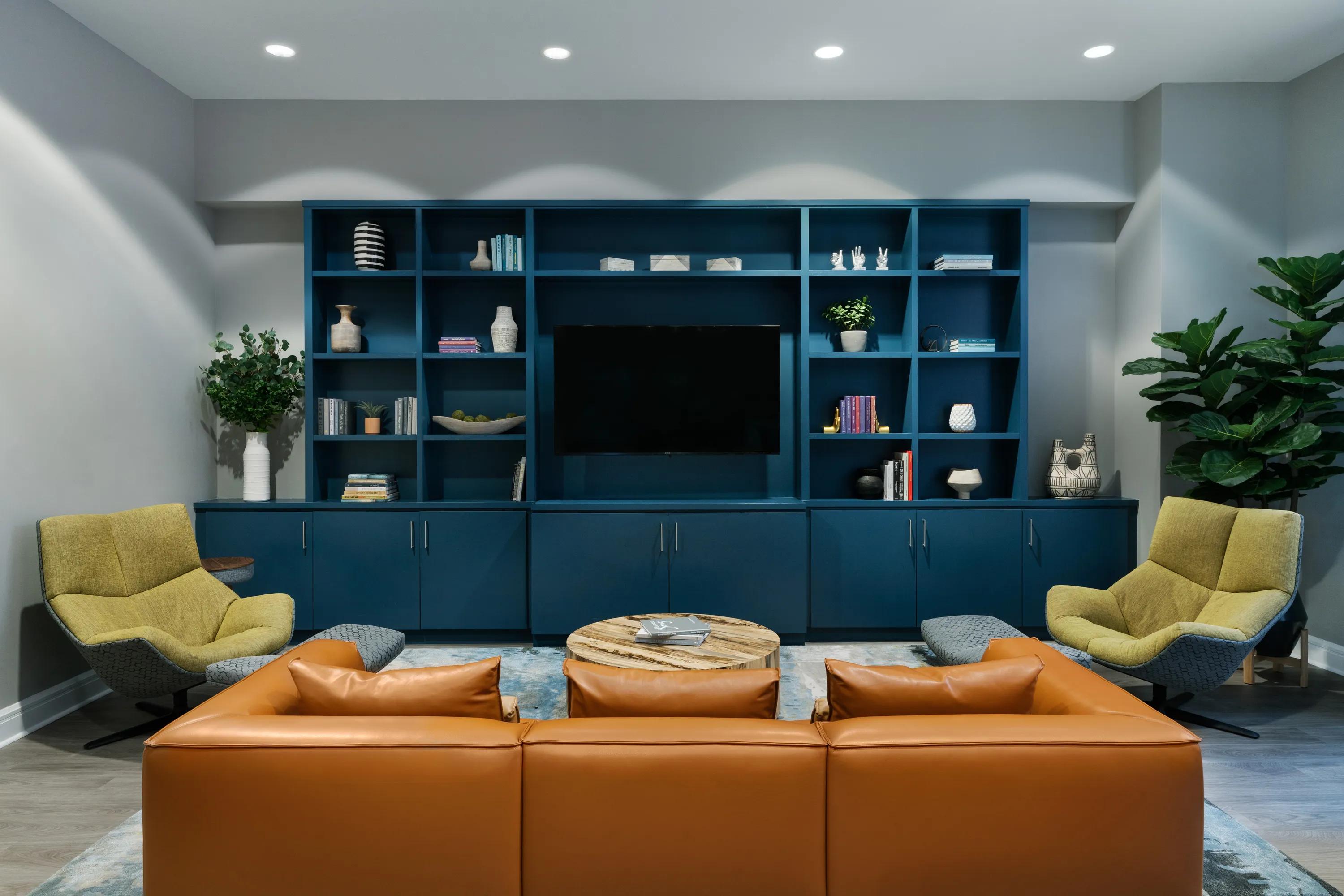 clubroom with large couch and tv metropolitan at 40 park apartment homes for rent in morristown nj