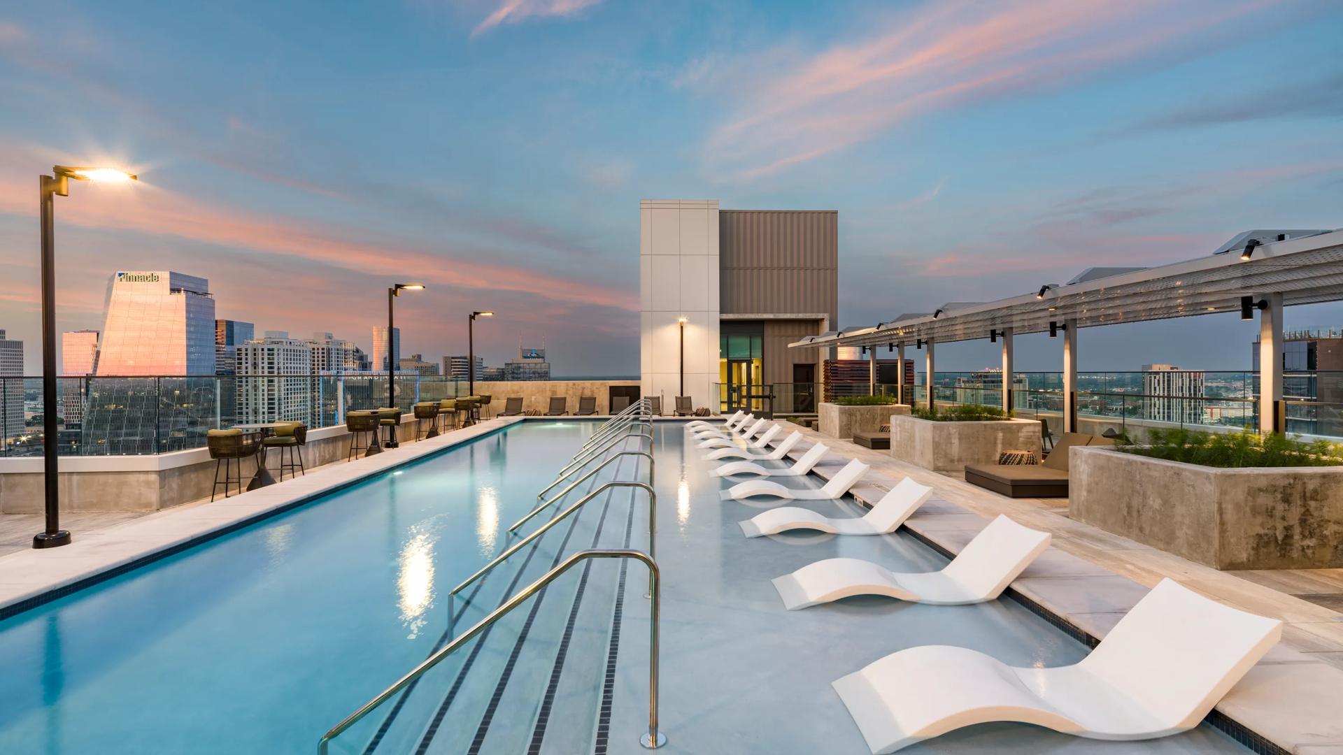rooftop pool at dusk modera mcgavock apartments in nashville