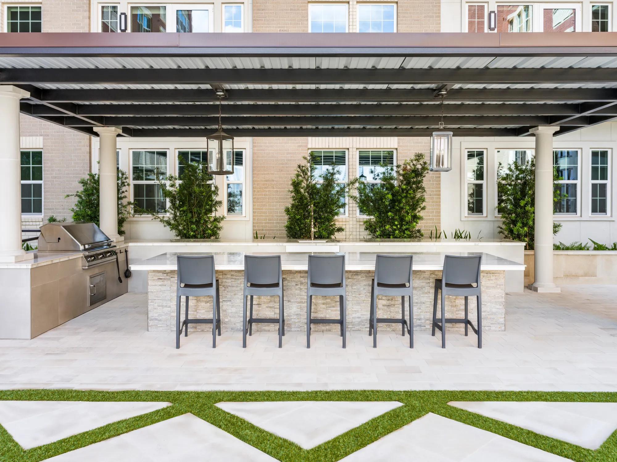 Poolside lounge area with outdoor bar and grilling area