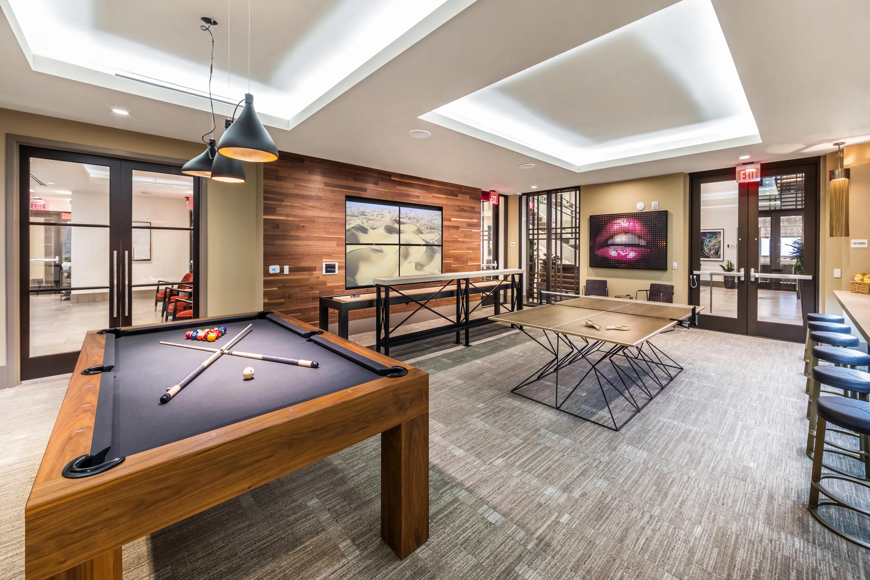 Game room with billiards, bar seating, and TVs 580 anton apartments in costa mesa ca