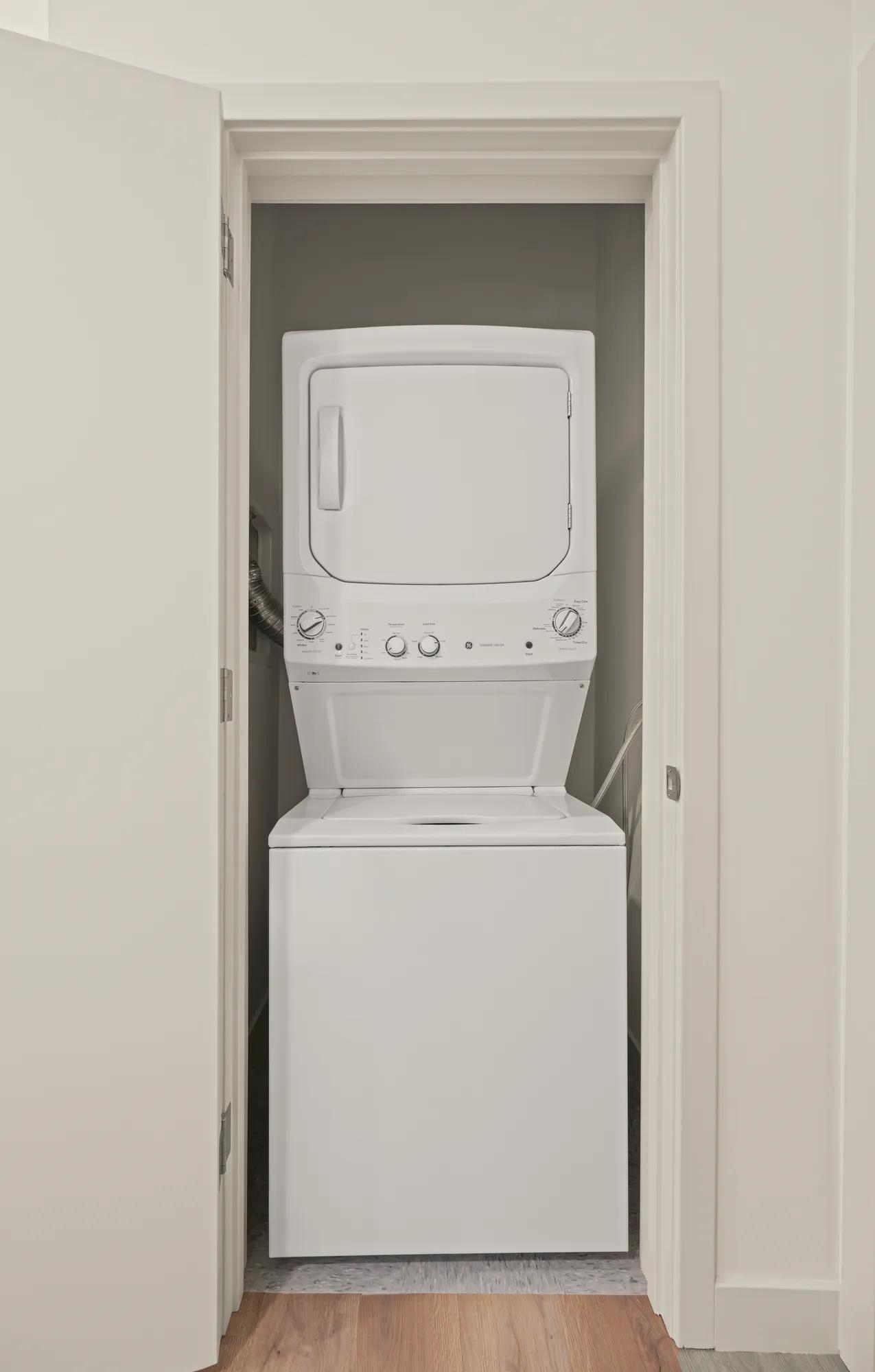 stacked washer and dryer in closet at modera newton apartment homes for rent in ma