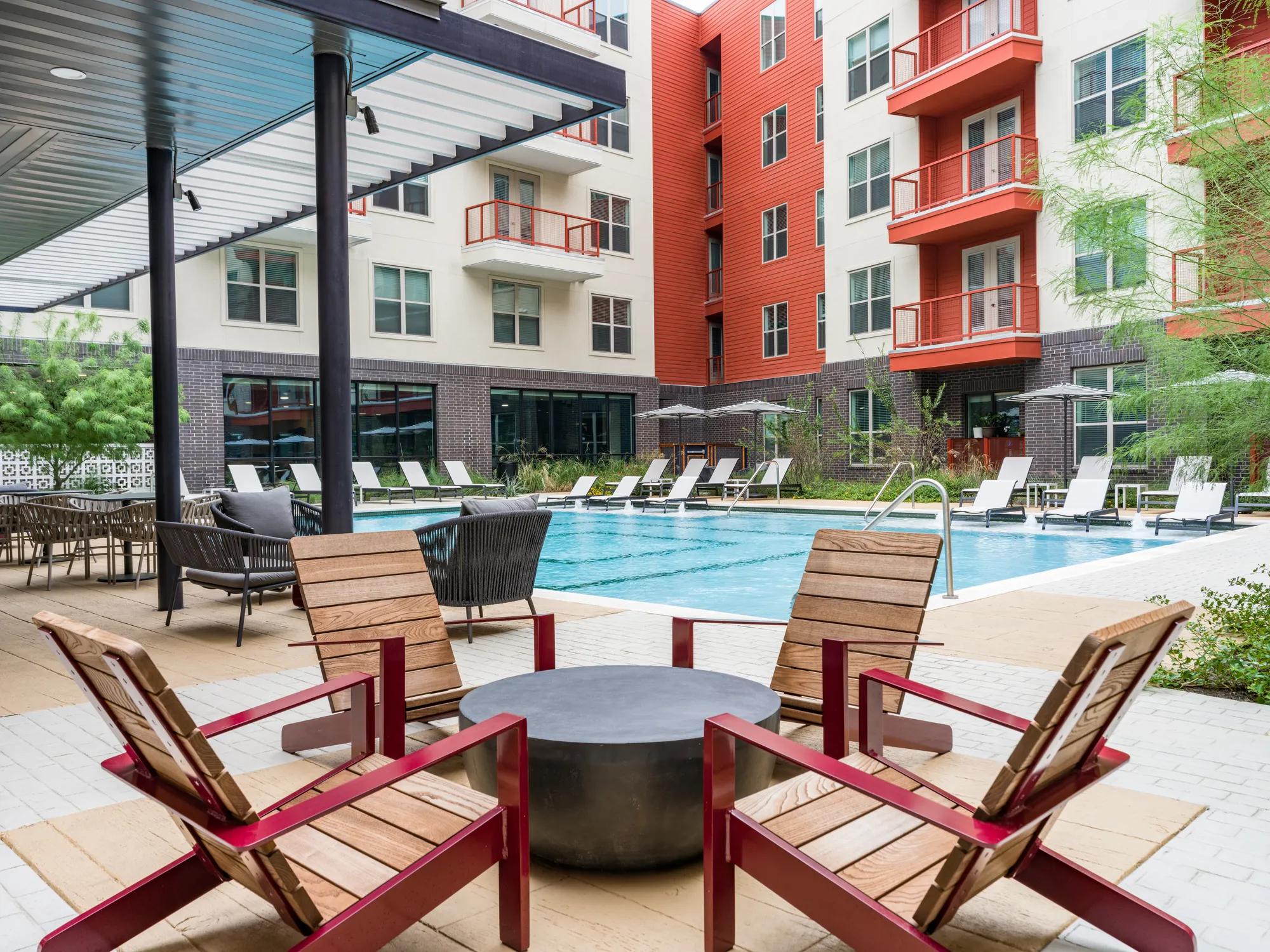 outdoor pool deck with seating and pool side lounge space