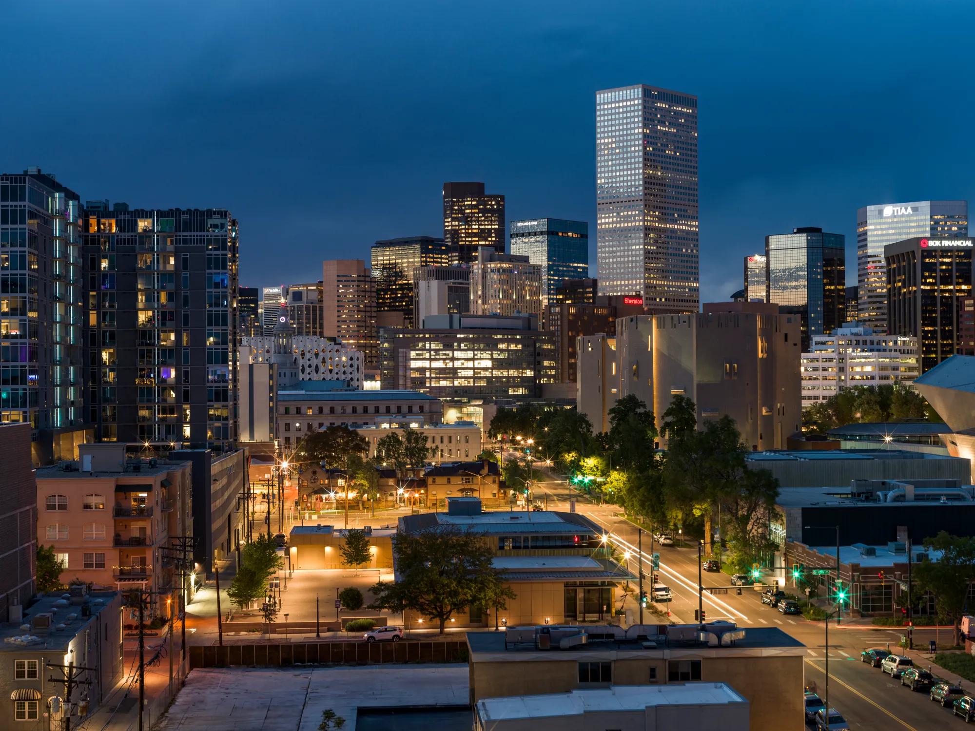 city views in the distance at dusk modera golden triangle apartment homes for rent in denver co