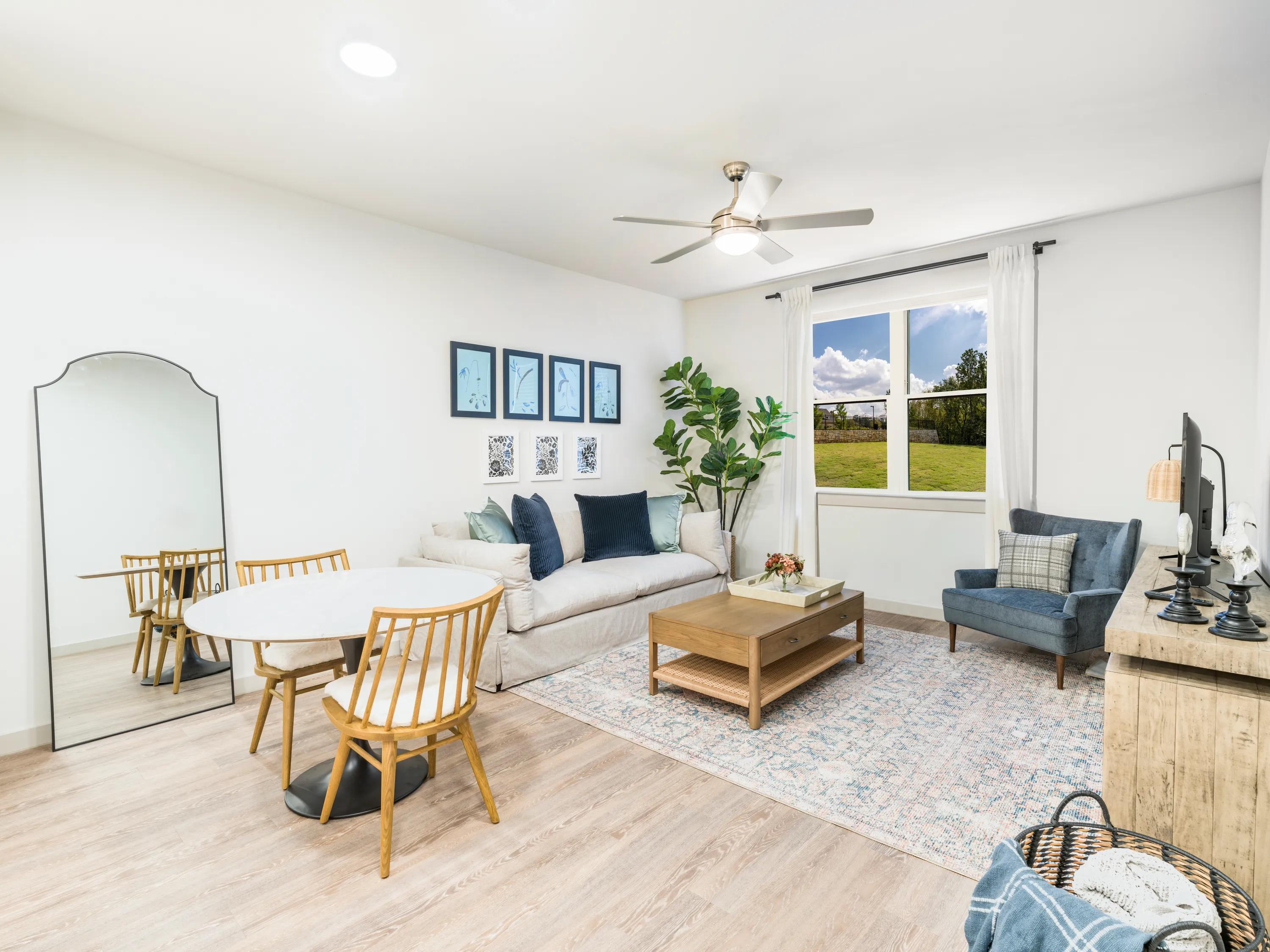 living area leading onto kitchen with large windows and sofa beckett west fork apartments tx