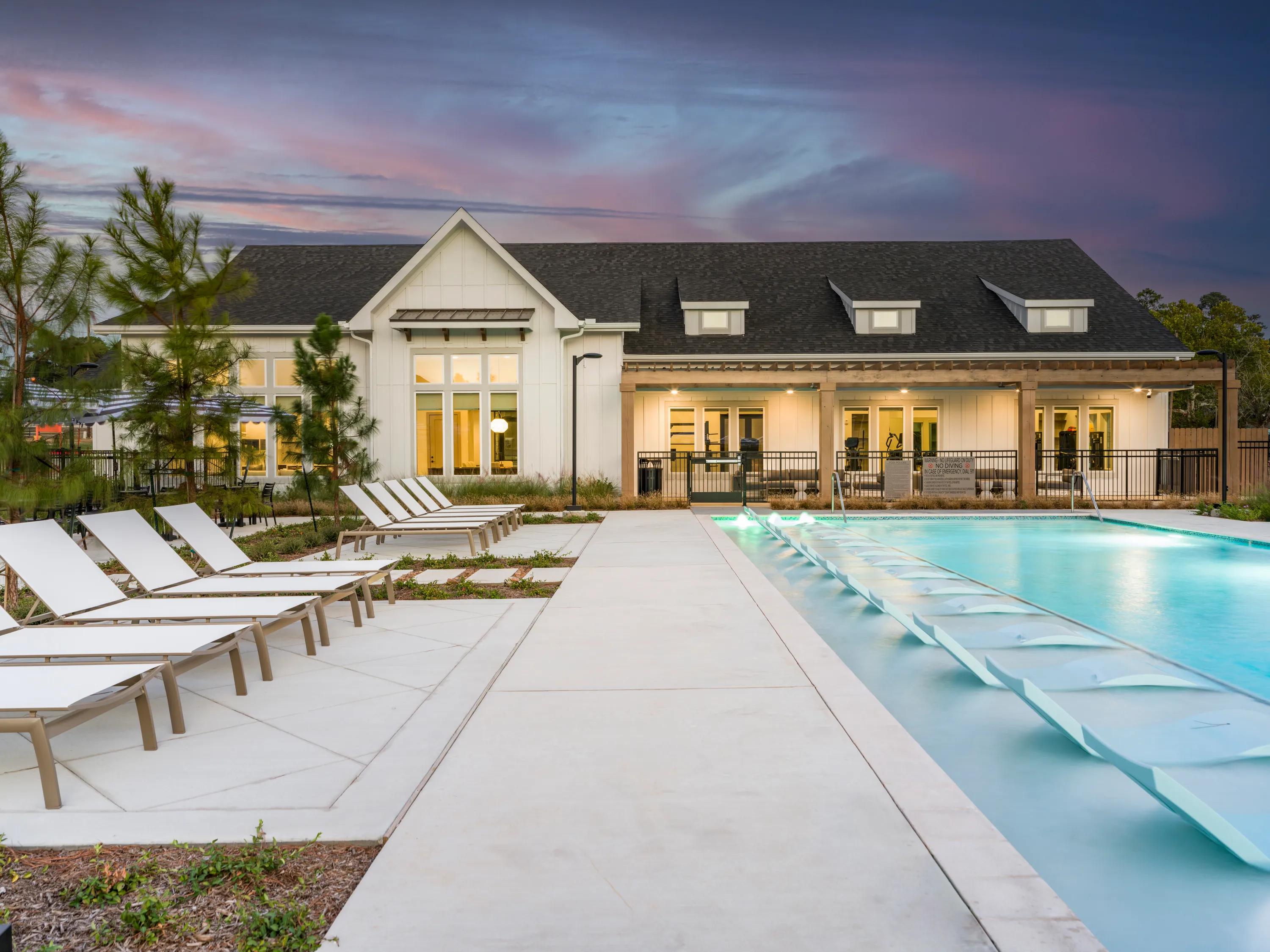 pooldeck with seating at dusk beckett west fork apartments conroe tx