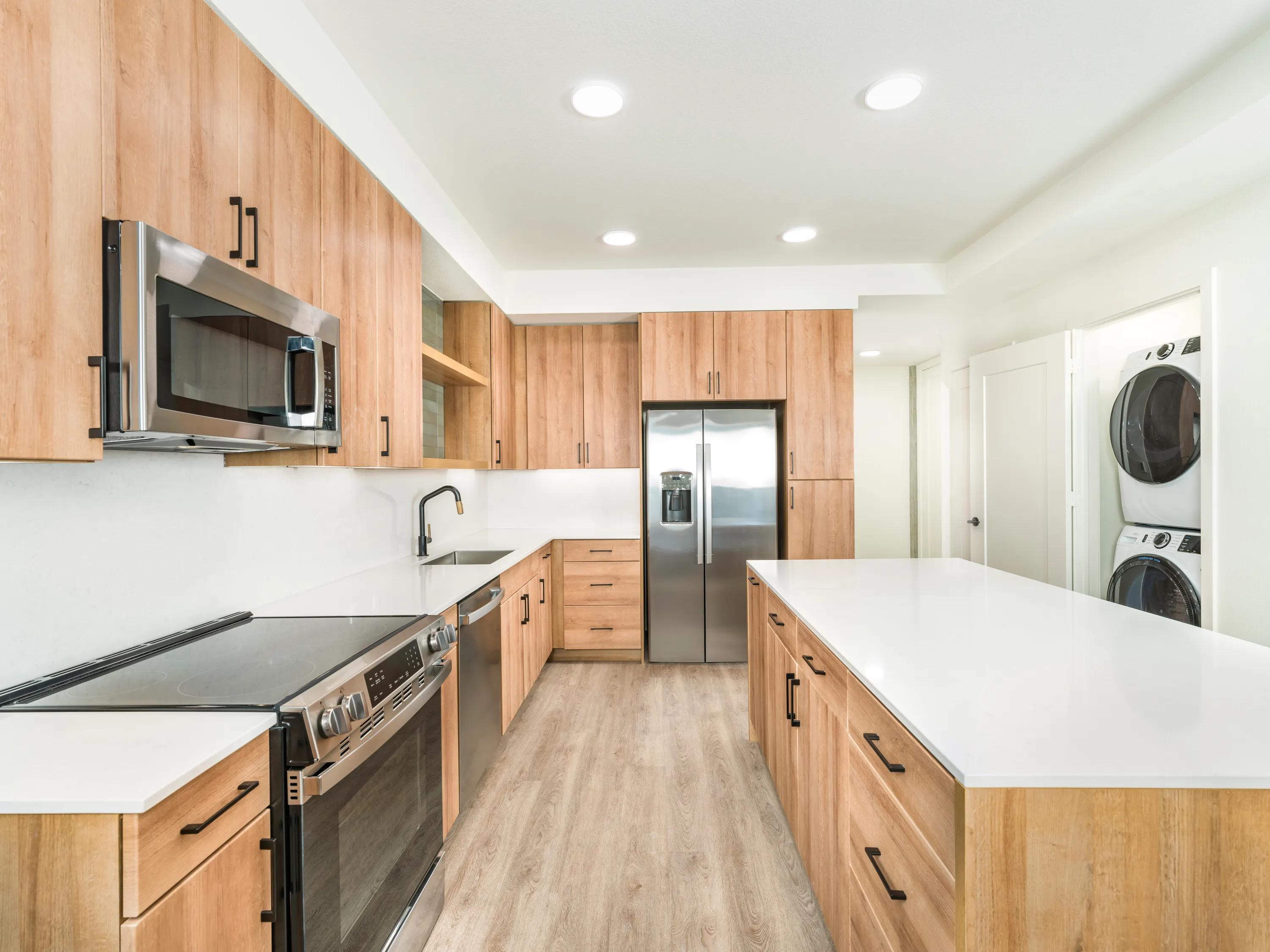 kitchen with stainless steel appliances large kitchen island modera st paul apartments in dallas tx