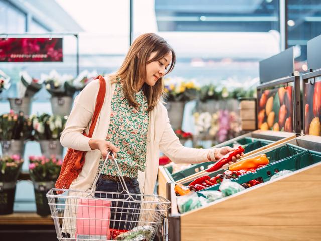 person shopping in produce section at grocery store modera walsh heights apartments in aledo tx