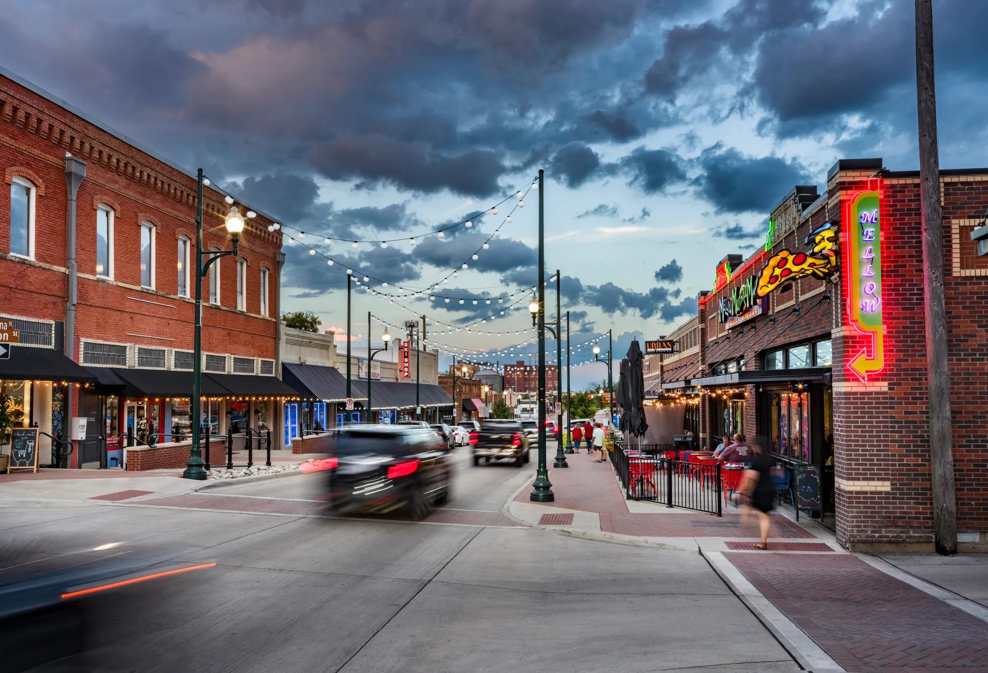 cars driving in downtown district lined with brick buildings modera mckinney ridge apartment homes for rent in texas