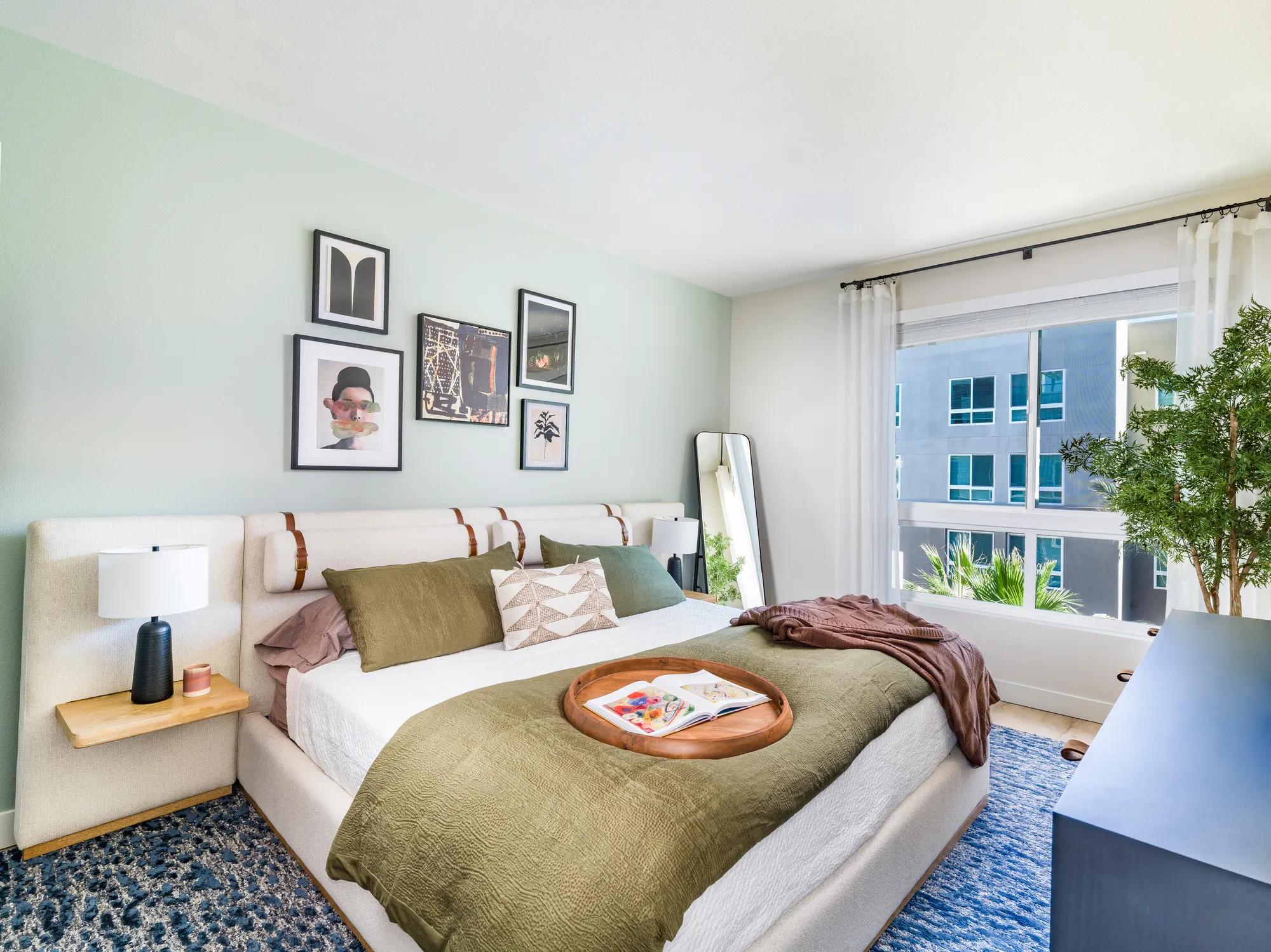 large bedroom with oversized window and furniture modera pomona apartment homes for rent in ca