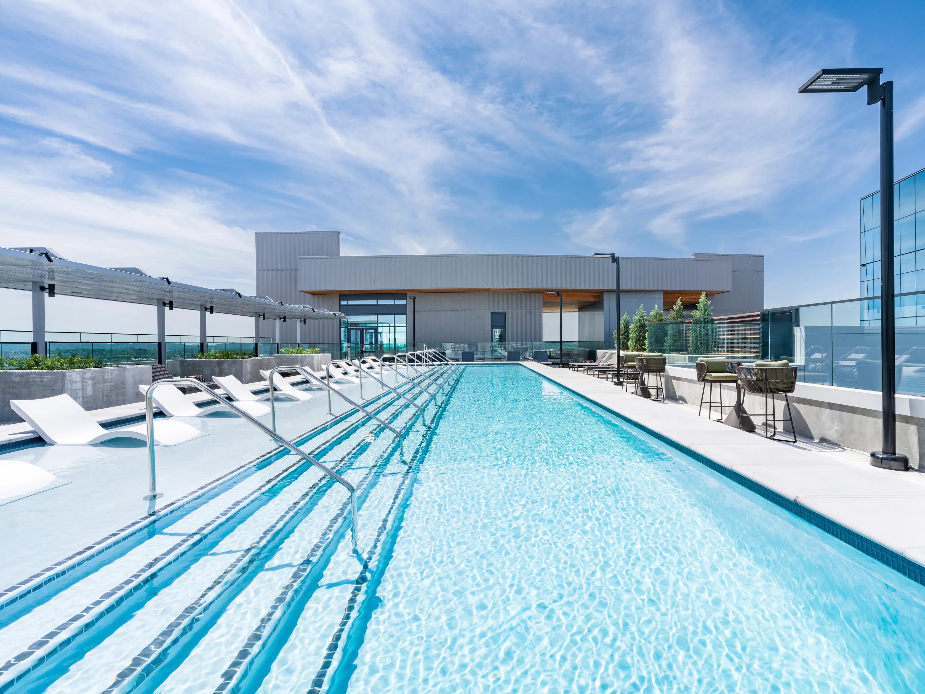 Rooftop pool with spacious sundeck, comfortable seating, and sweeping views modera mcgavcok