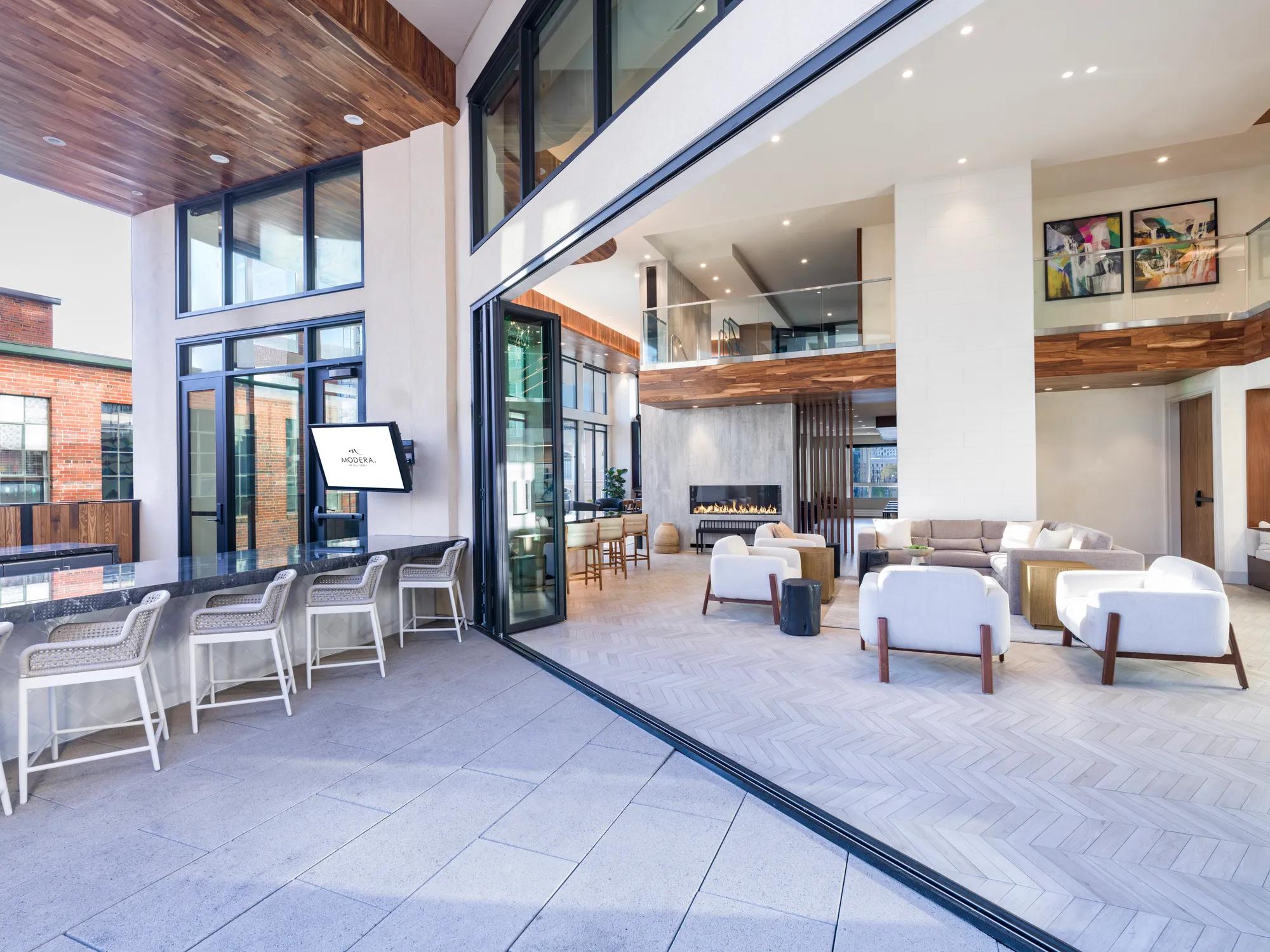 large door opening to outdoor courtyard and pool deck modera golden triangle apartment homes for rent in denver co