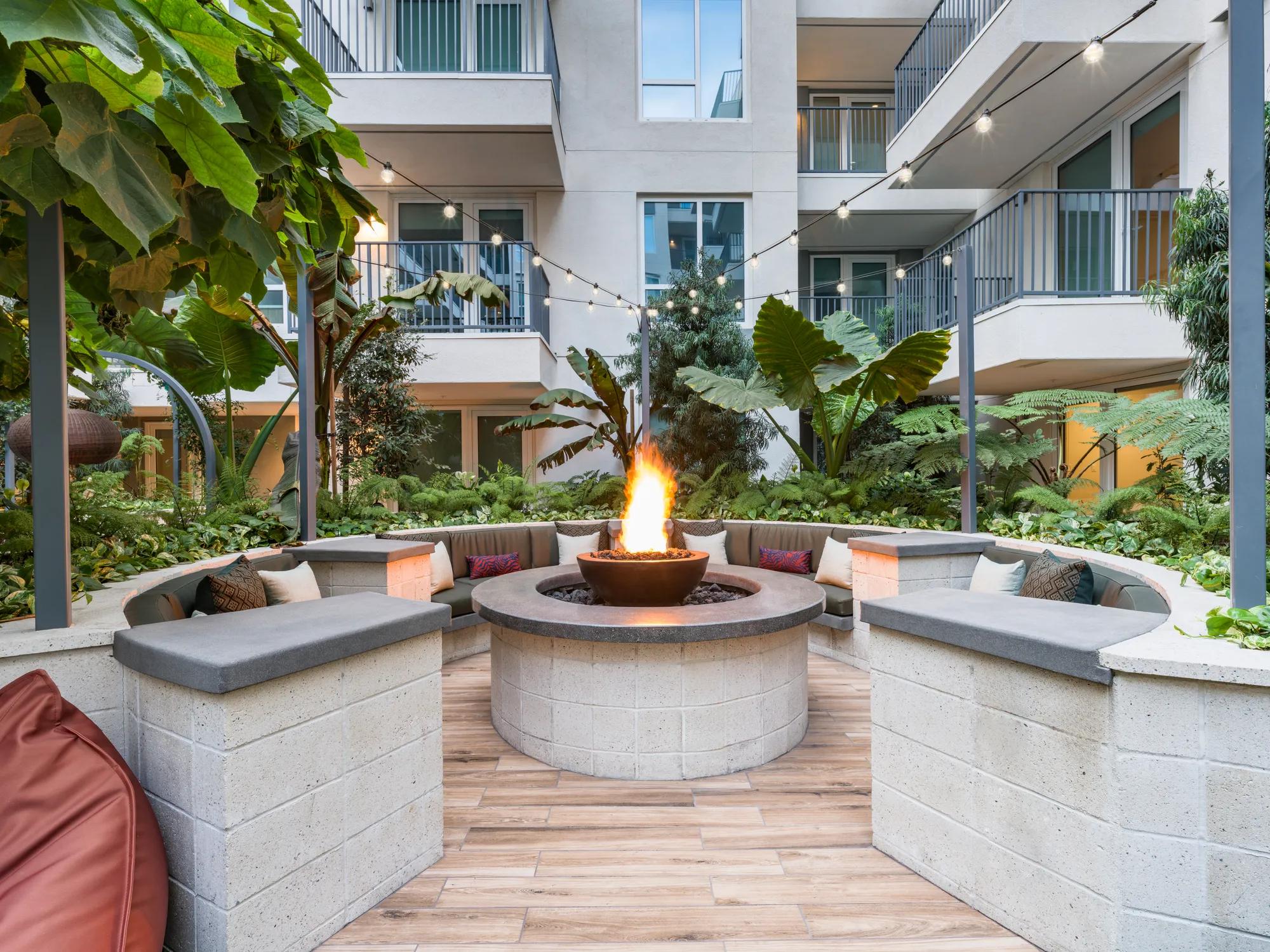 outdoor courtyard with seating and fireplace at modera argyle apartment homes for rent in los angeles ca
