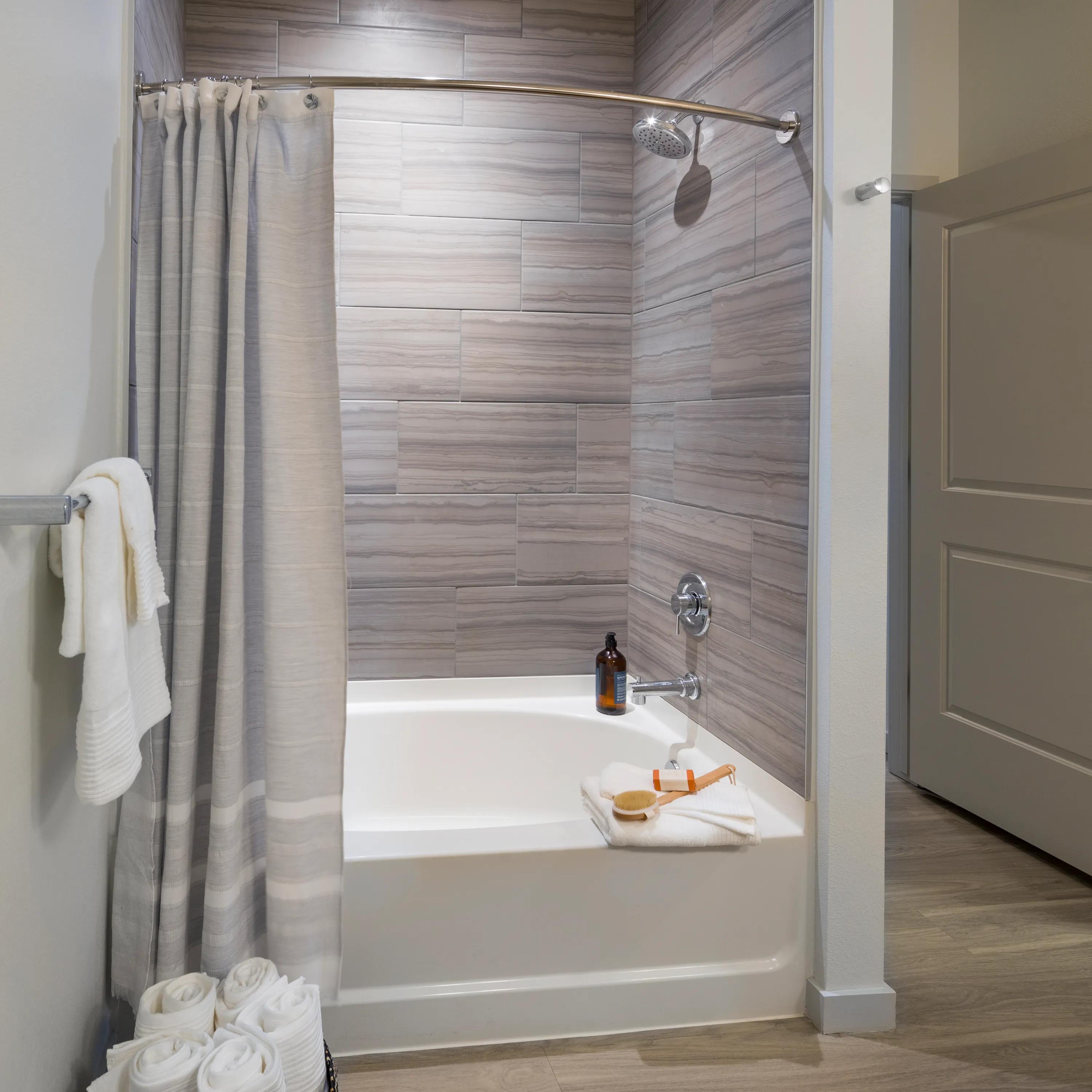 Oversized tub-shower in bathroom in apartment at Modera West Wash Park.