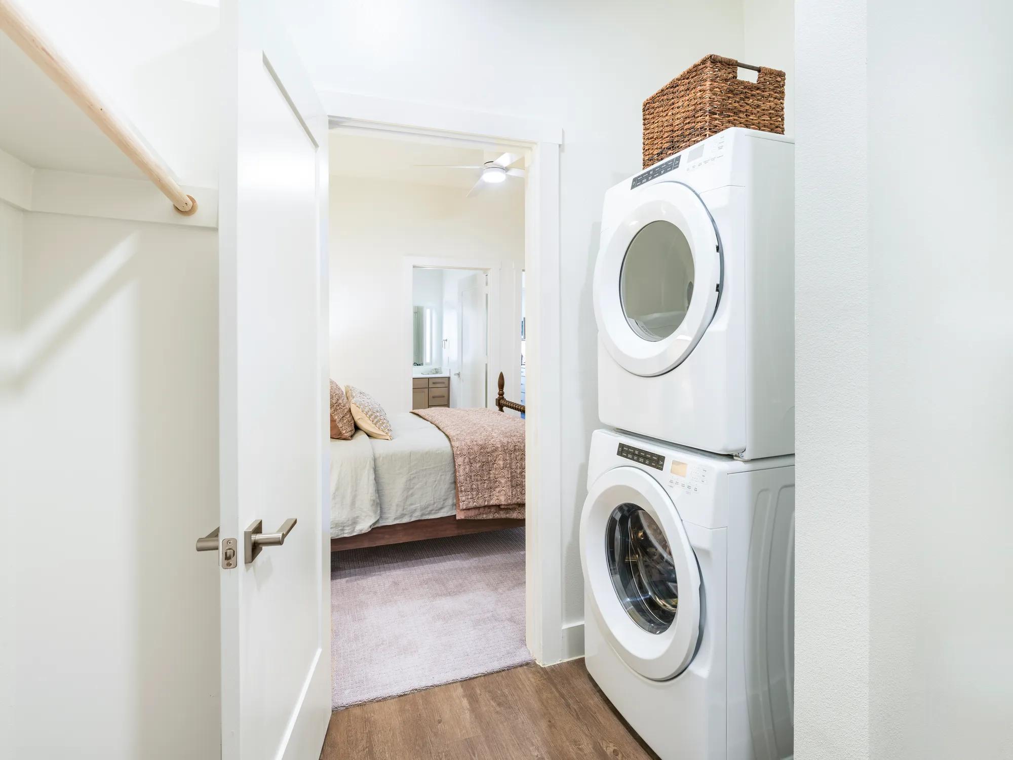 washer and dryer in closet leading to bedroom modera trailhead apartment homes for rent in dallas texas