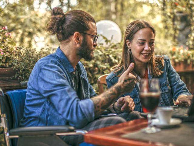 man and woman having drinks at table outside modera mcgavock apartment homes for rent in nashville tn