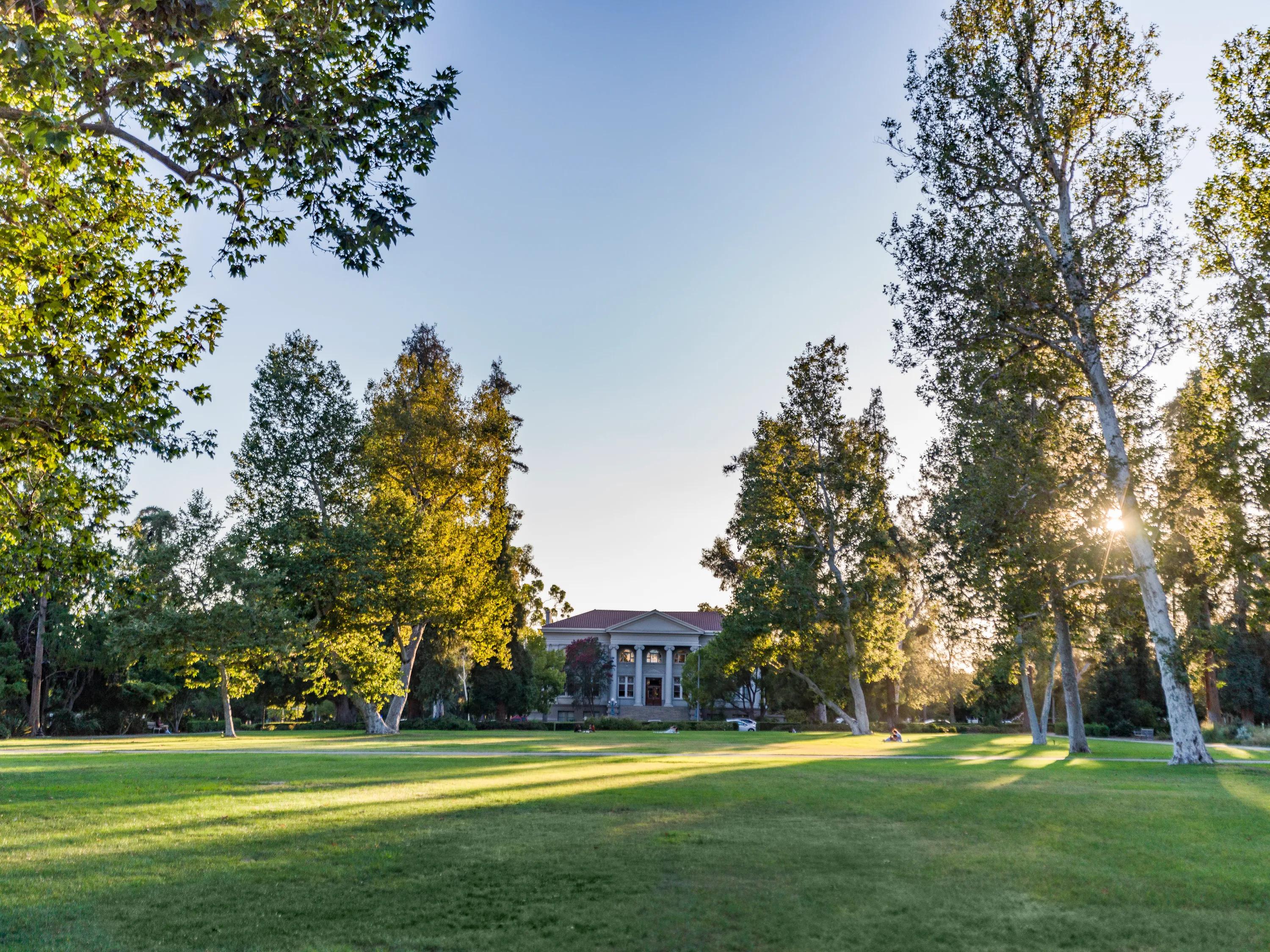 public building campus with grass and trees on blue sky day modera pomona apartment homes for rent in ca