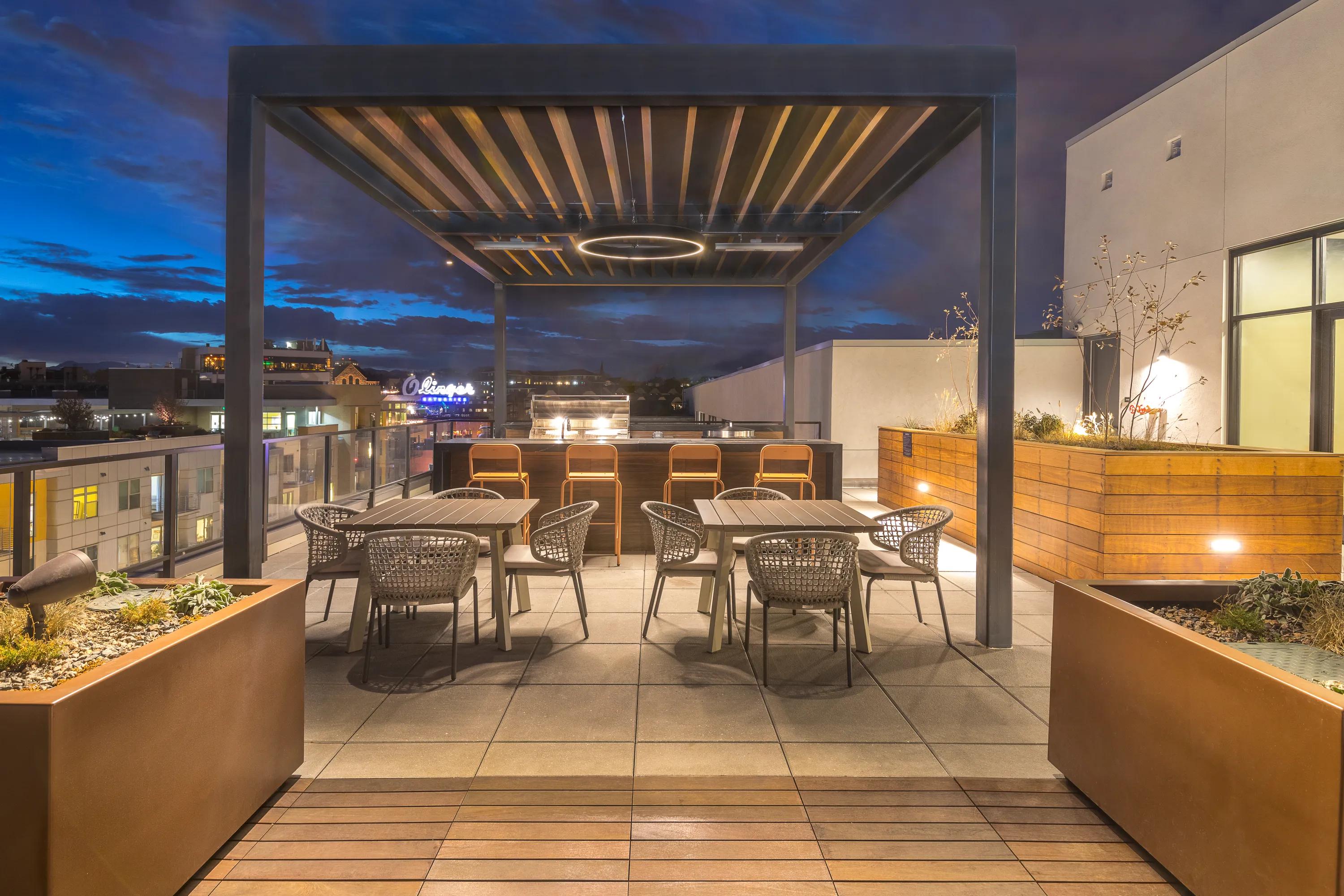 Outdoor dining area and BBQ grilling stations modera lohi apartments in denver co