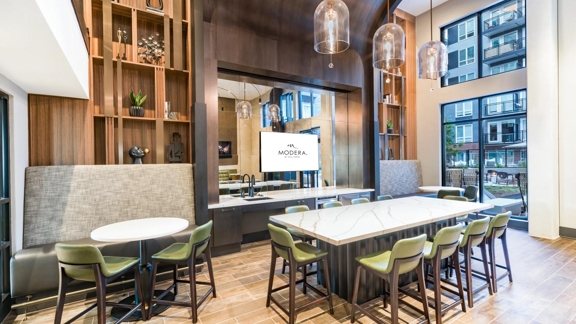 clubroom with large windows and fireplace with seating modera h street apartment homes for rent in washington dc