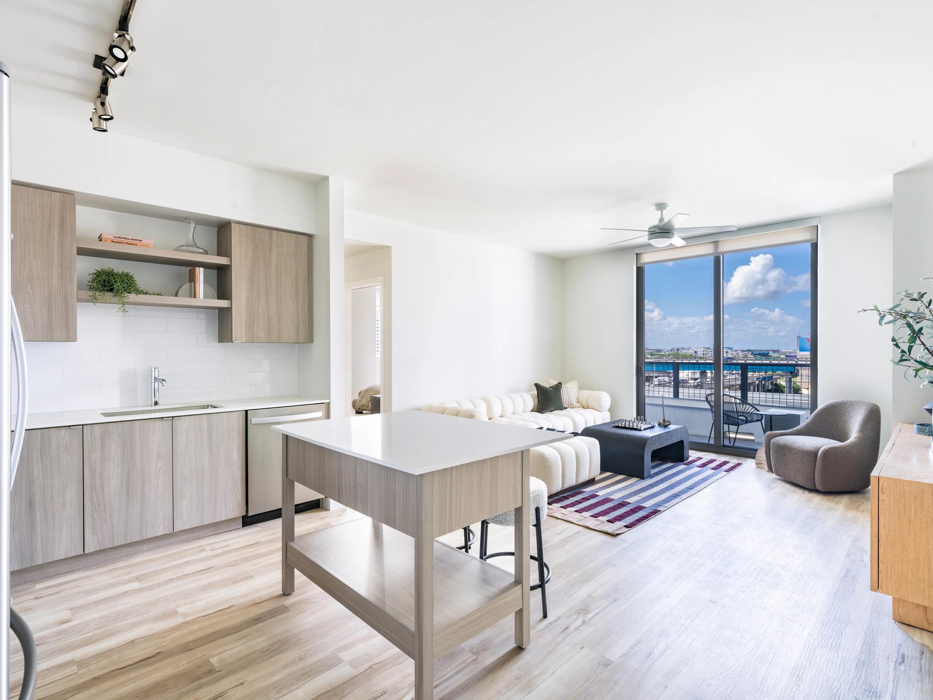 kitchen with premium cabinetry and stainless steel appliances and large island modera riverside apartment homes for rent in miami fl