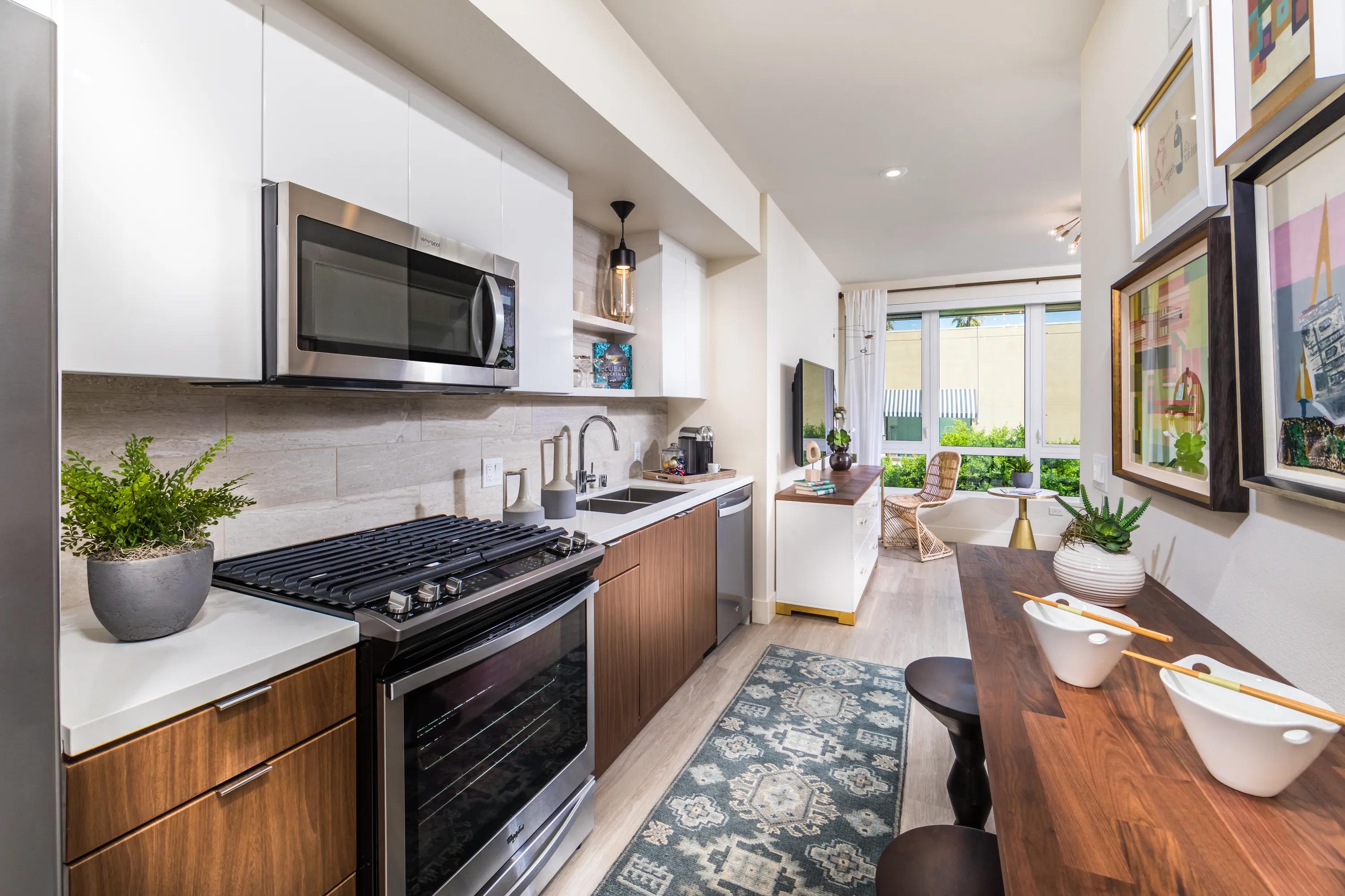 Gourmet kitchens with premium quartz countertops, full-height backsplash, and under-cabinet lighting 580 anton apratments in costa mesa ca