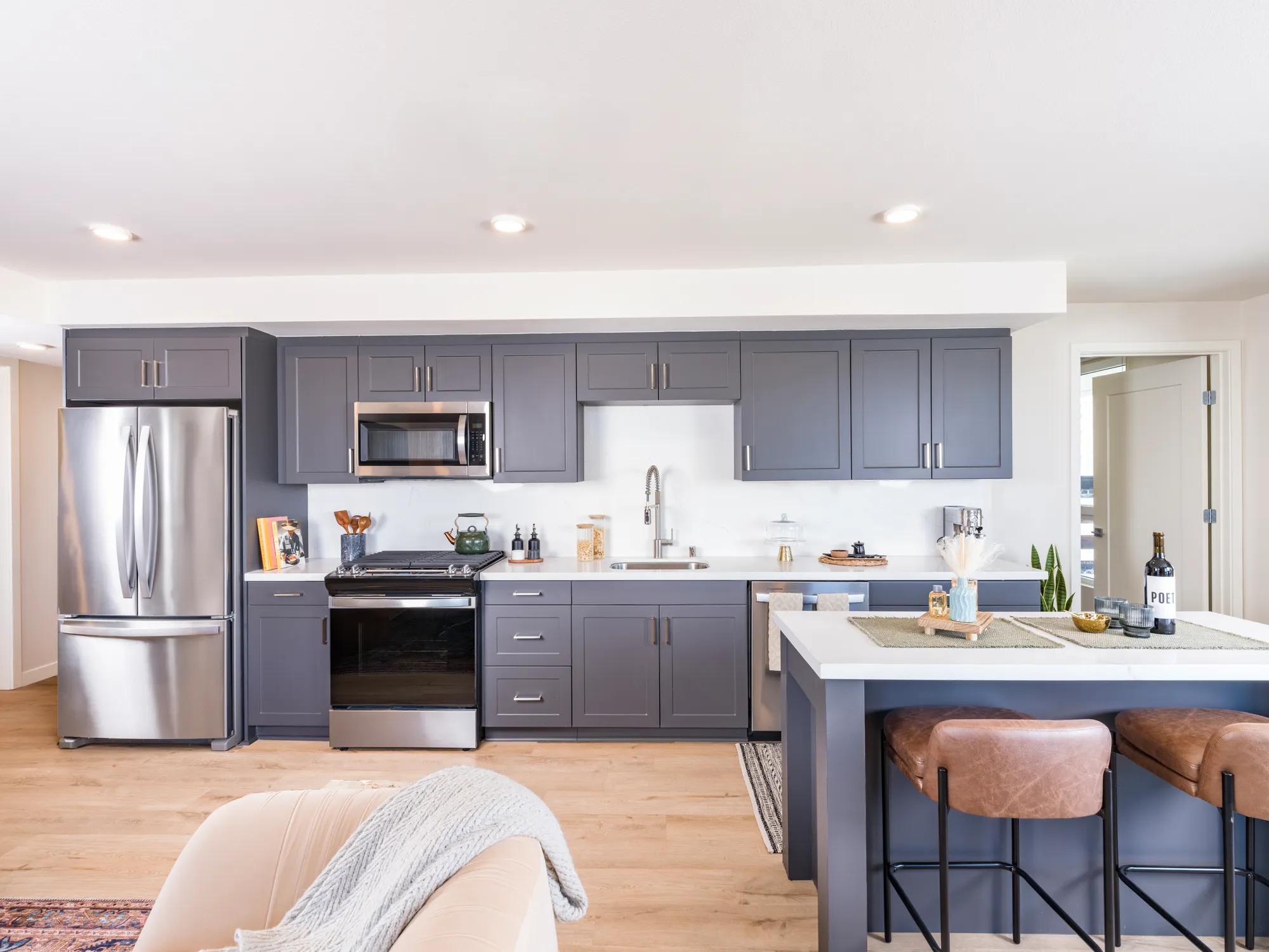 stainless steel applicanes in dark colored kitchen modera argyle apartments for rent in los angeles ca