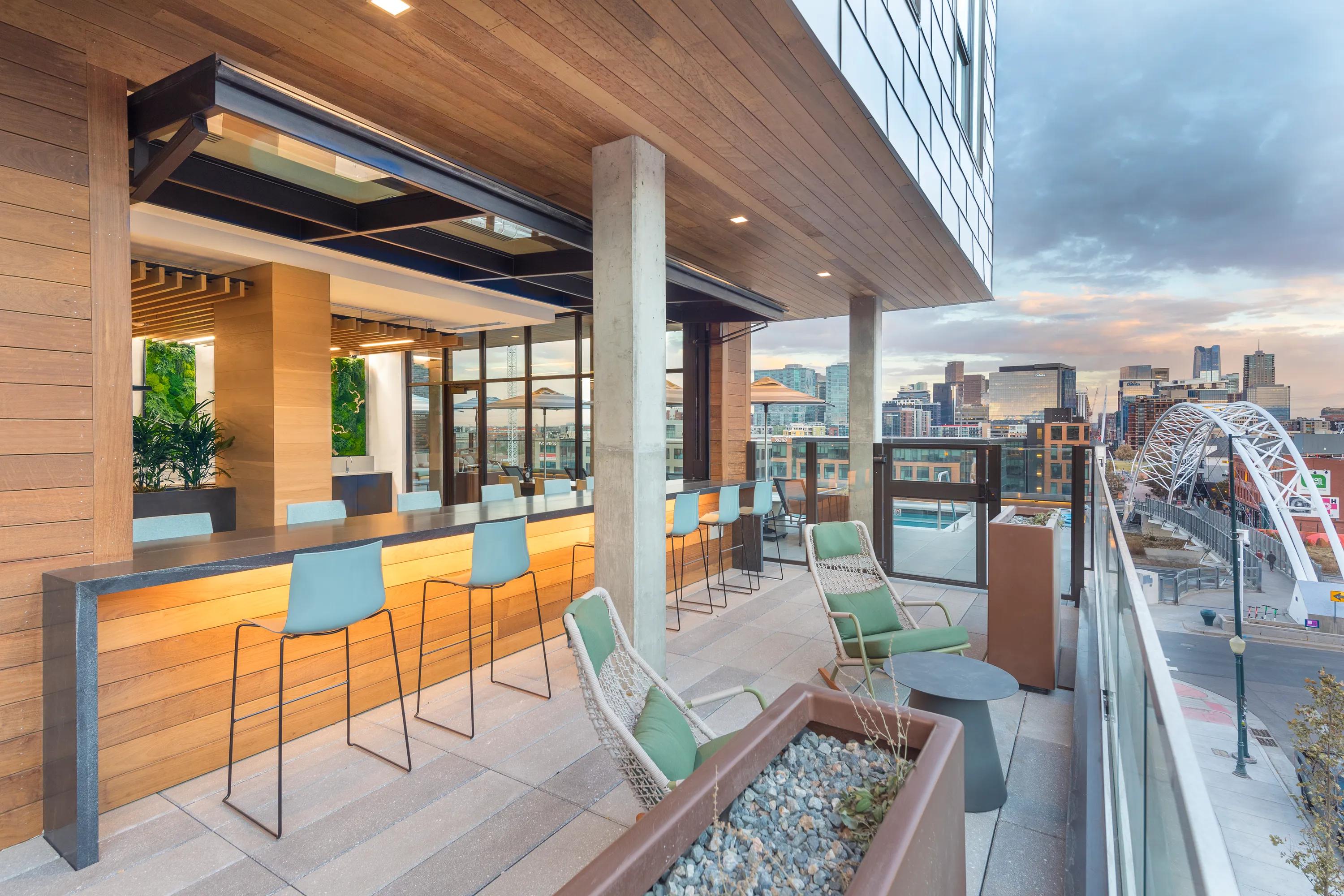 Outdoor lounge with dining areas and gorgeous views of Denver modera lohi apartments in denver co