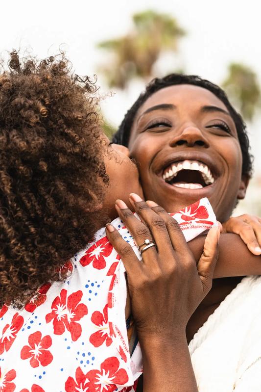 mother and daughter hugging and smiling alister oak hill apartments in austin tx