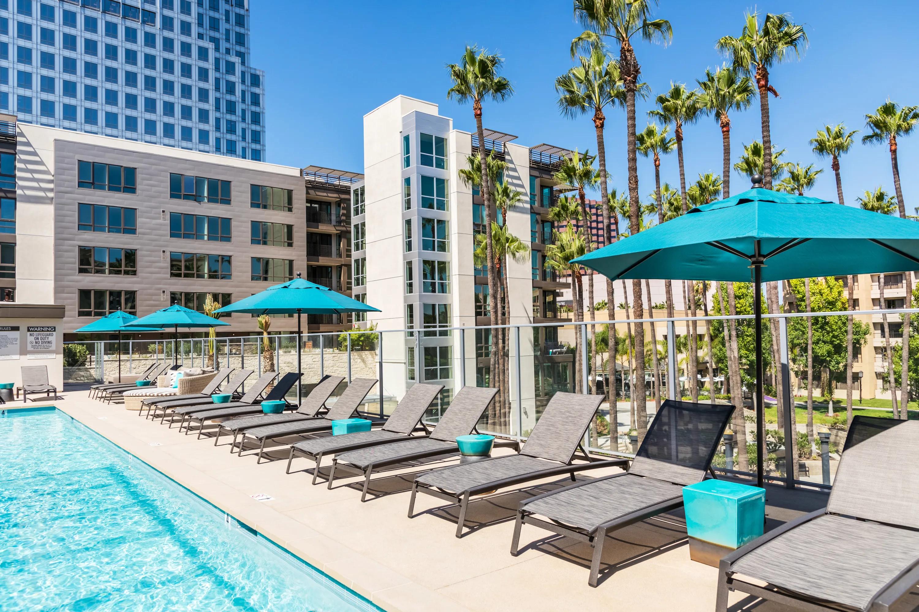 Elevated resort-inspired pool deck and spa with daybed and chaise lounges 580 anton costa mesa