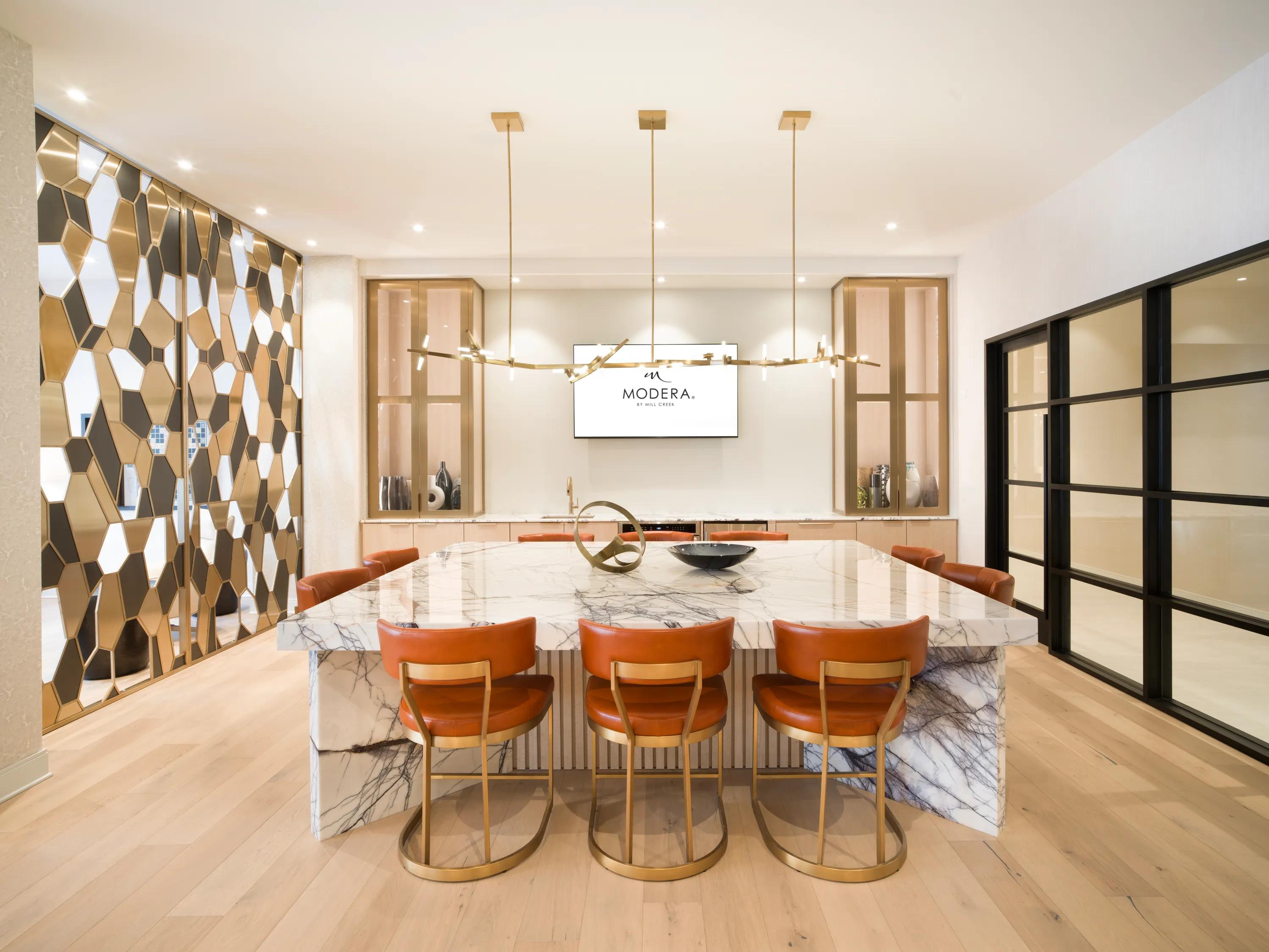 Expansive clubroom with gathering space, demonstration kitchen, game table, and fireplace