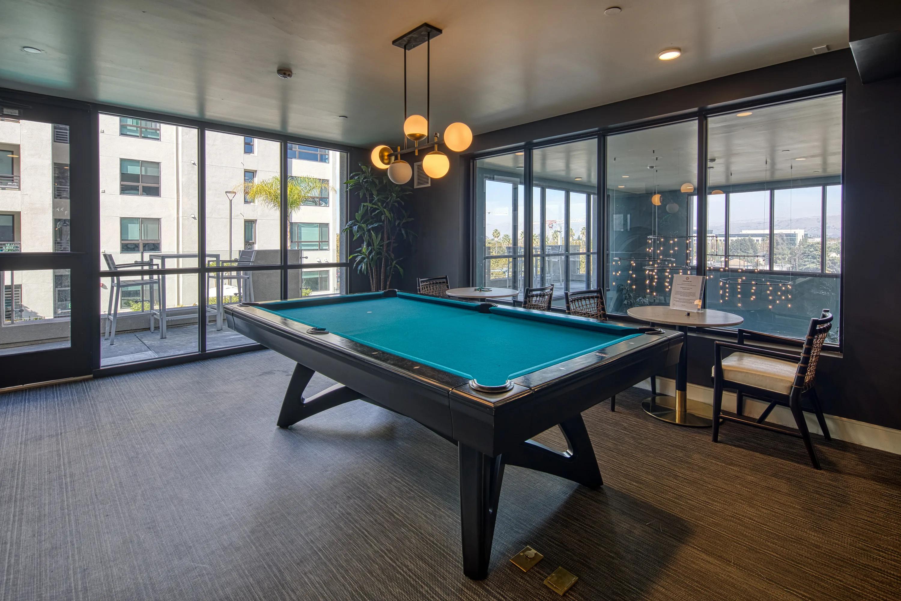Game lounge with billiards table and bar seating
