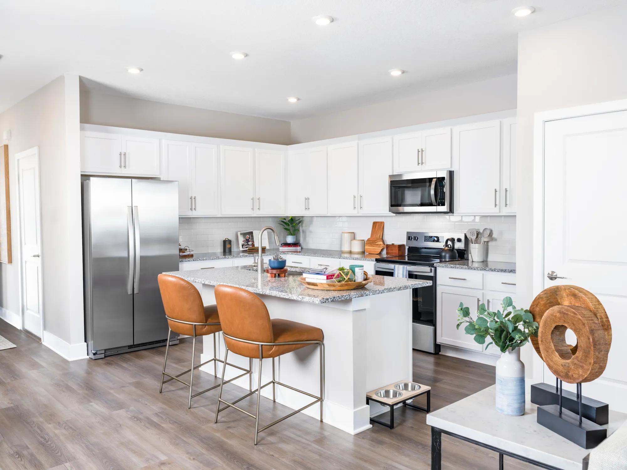 kitchen with island and stainless steel appliances amavi kissimmee single family homes for rent in florida