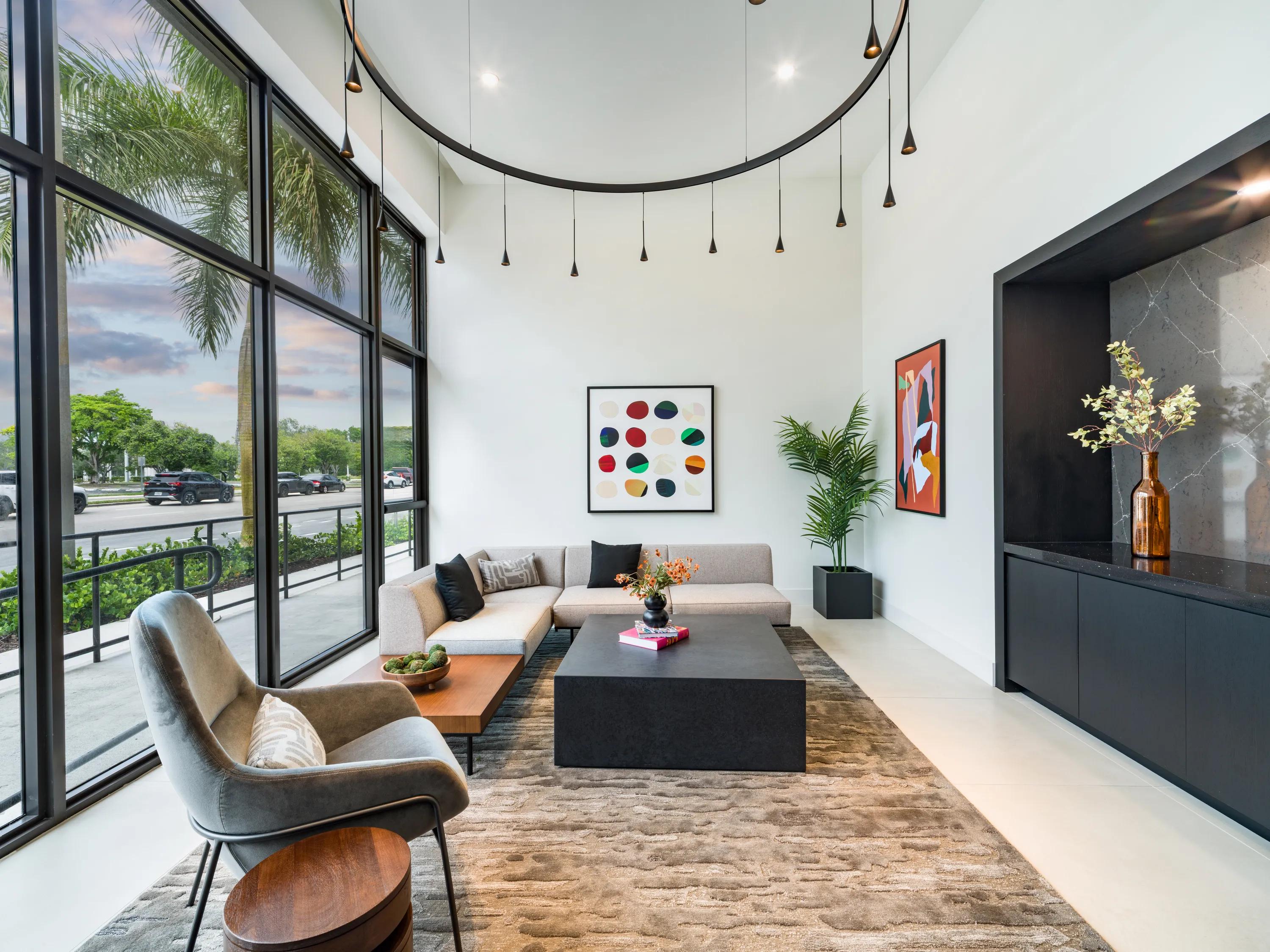 Double-height lobby lounge with floor-to-ceiling windows modera coral springs phase 2 apartments in coral springs fl