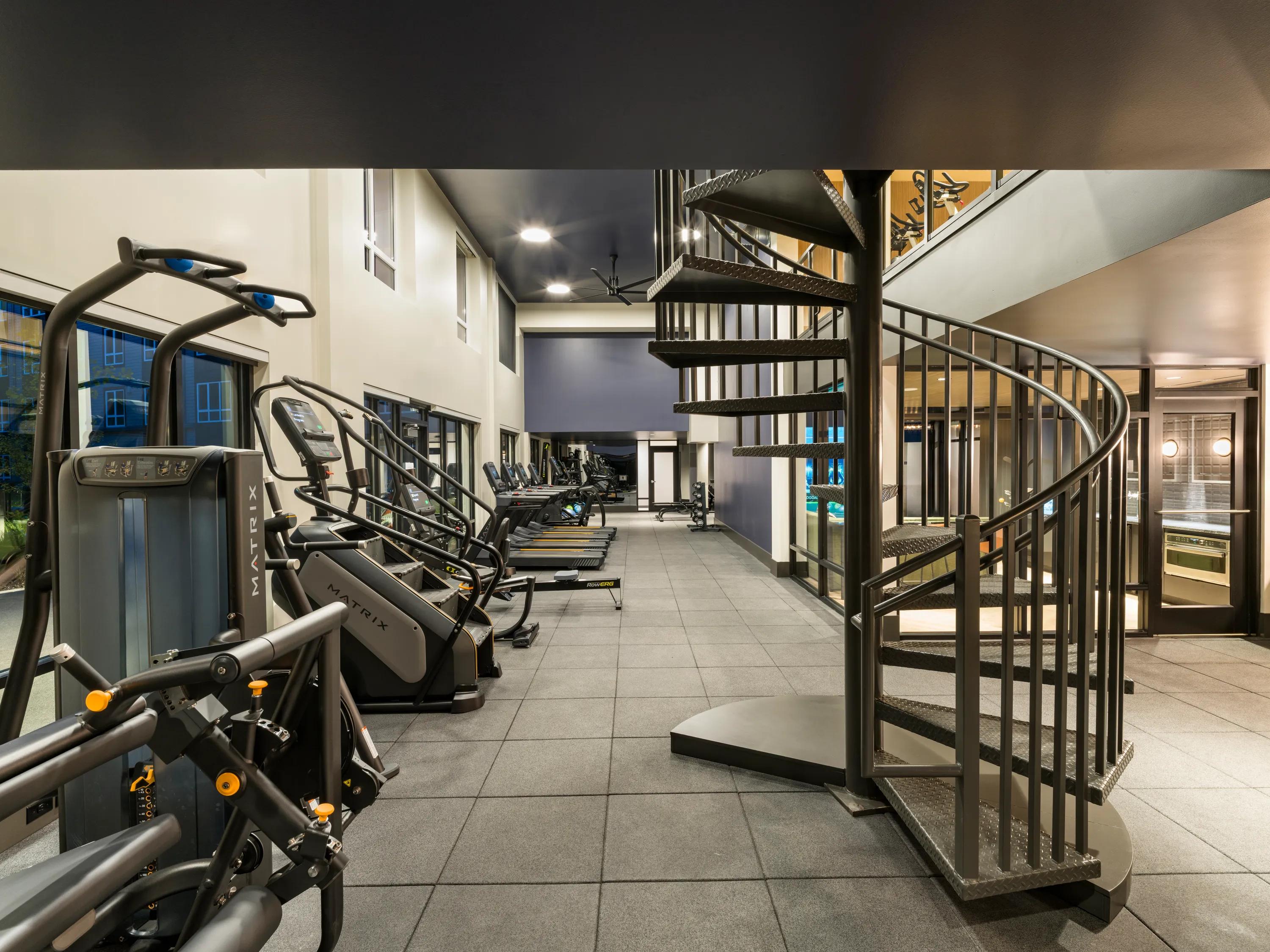 cardio equipment in two story fitness center with large windows modera beaverton apartment homes for rent in or