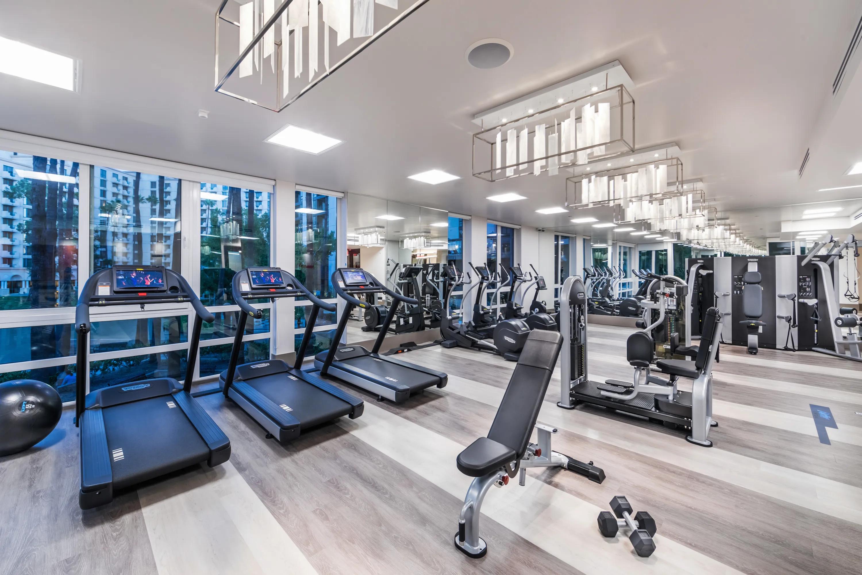 Club-quality fitness studio with cardio and weight machines, overlooking the lake 580 anton costa mesa apartments