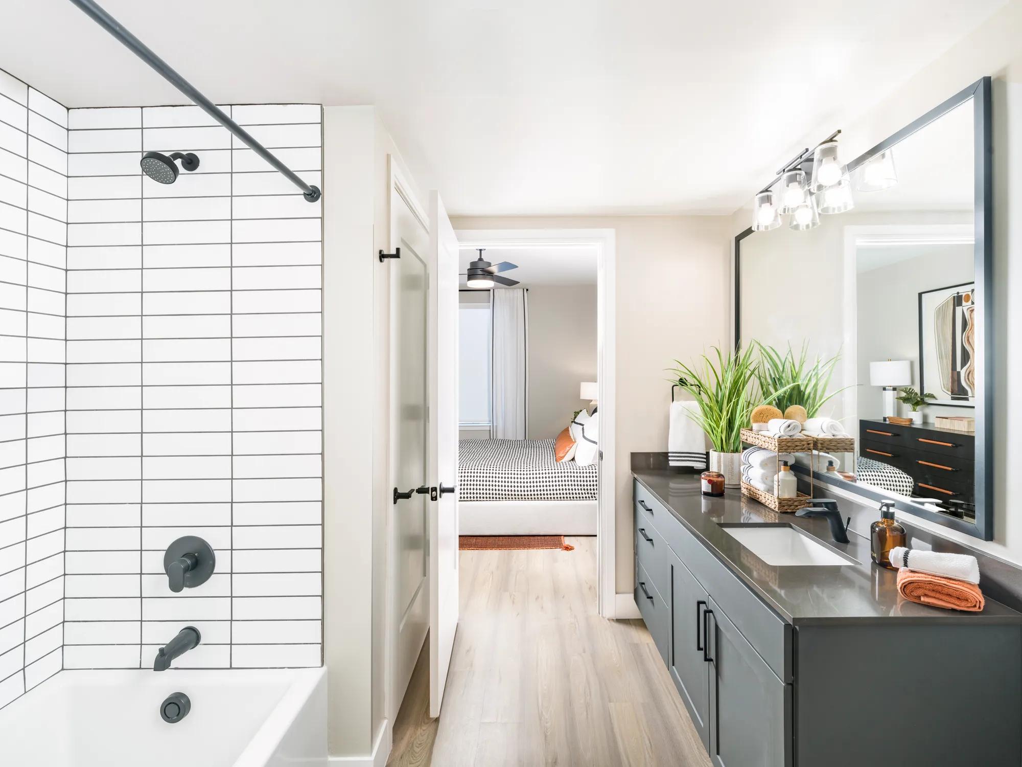 tiled bathtub and large bathroom adjacent to bedroom at modera scottsdale apartment homes for rent in scottsdale az
