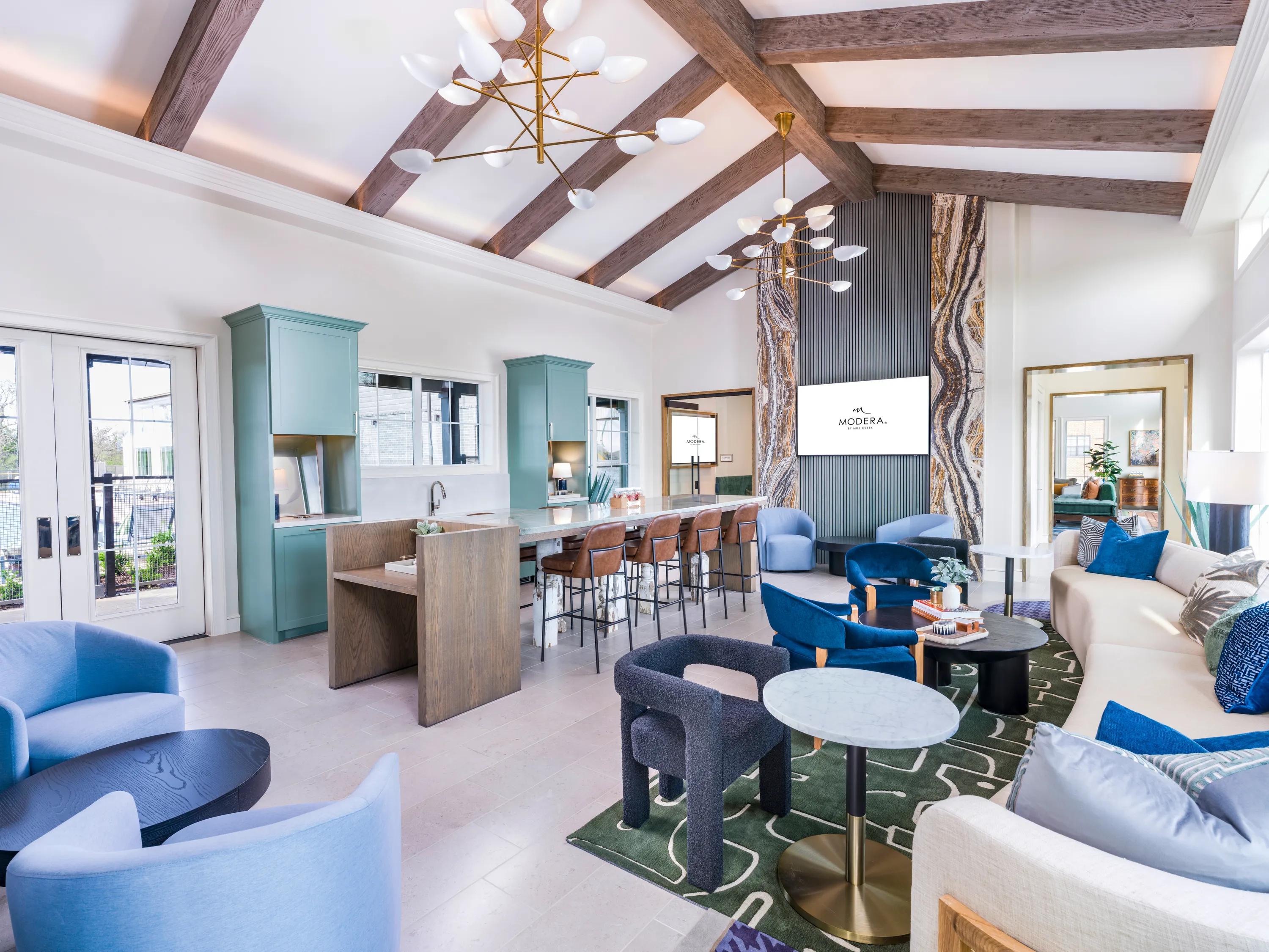 stunning clubroom with large fireplace and seating areas with natural light modera mckinney ridge apartment homes for rent in tx