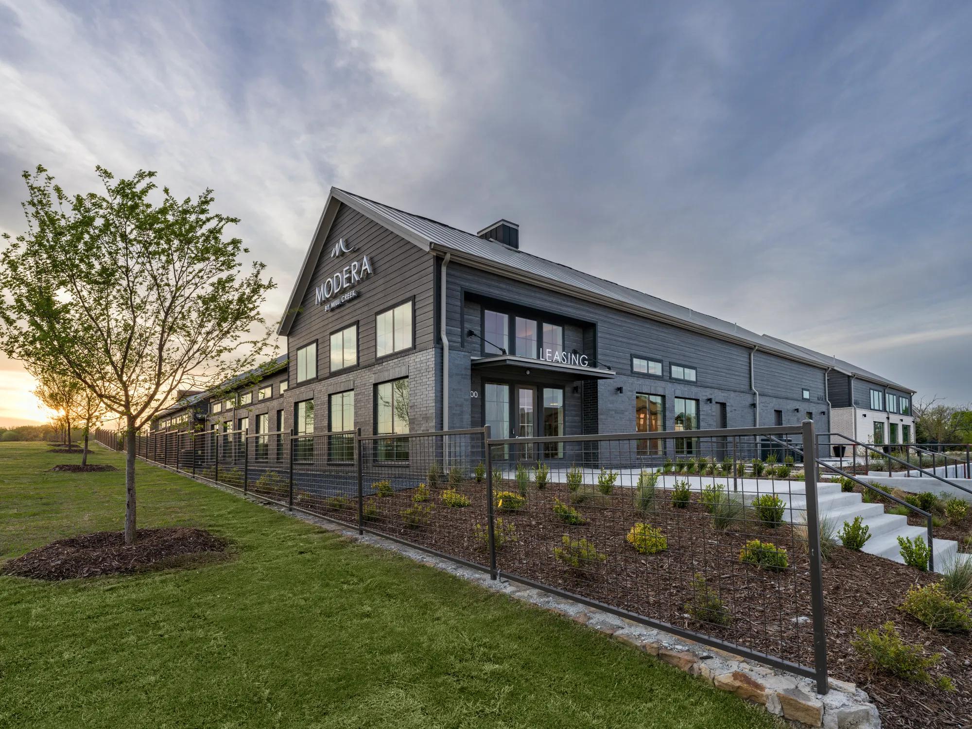 exterior building leading onto grassy green space modera mckinney ridge apartment homes for rent in tx