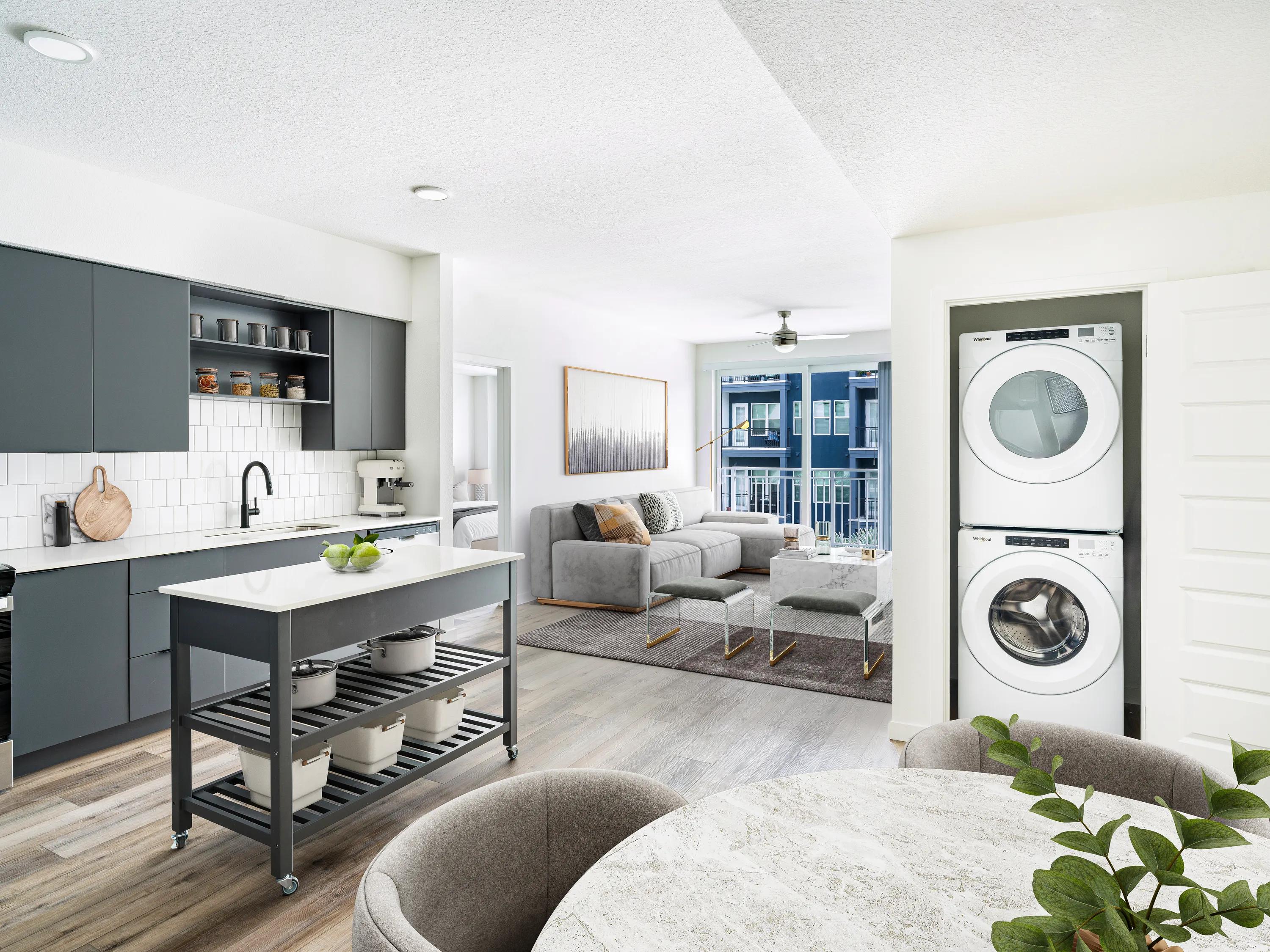 dark kitcehn cabinets with in home washer and dryer modera encore apartments in tampa fl