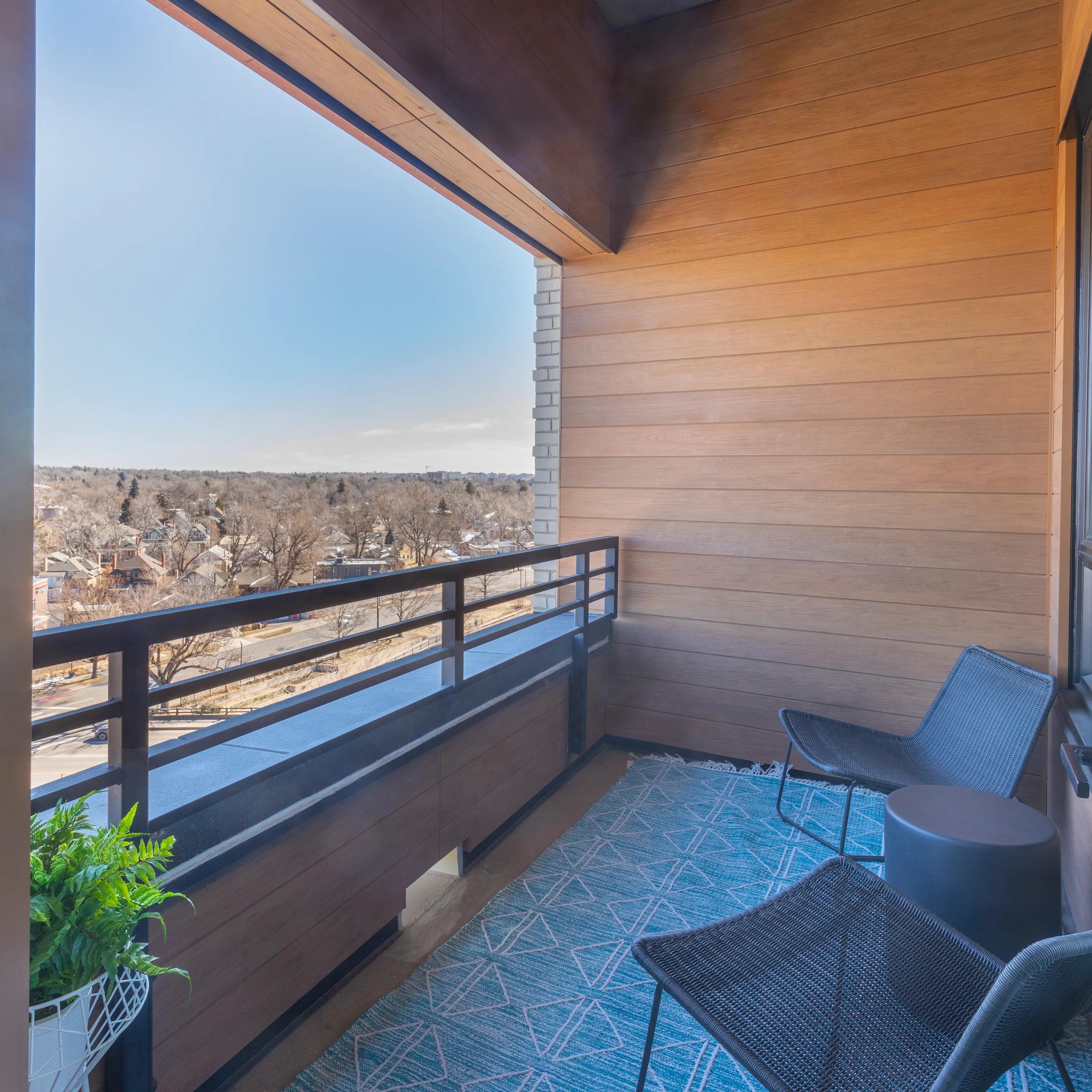 Balcony with city view at Modera West Wash Park apartments in Denver.