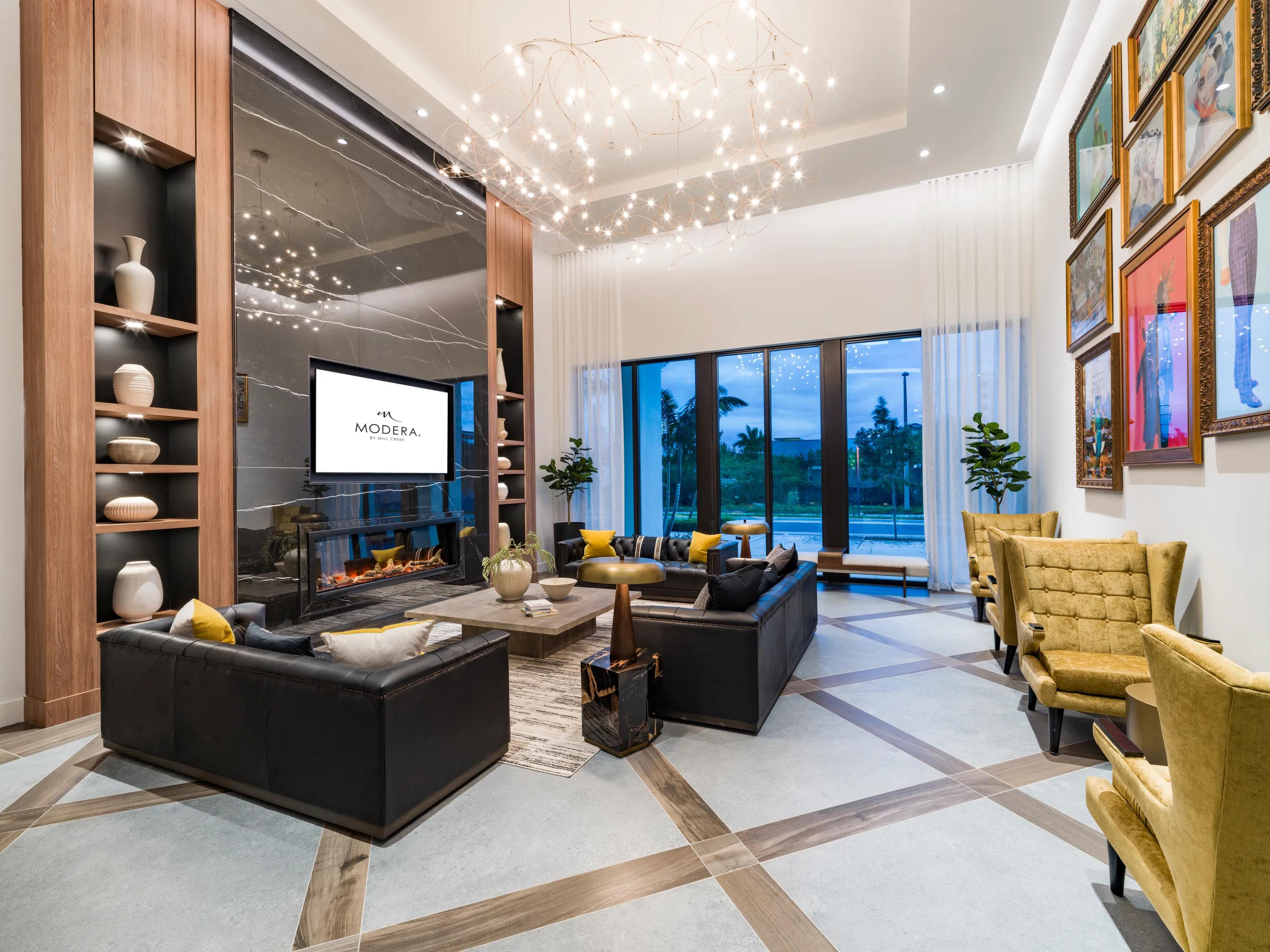 Media lounge with fireplace and comfortable seating modera aventura miami apartments
