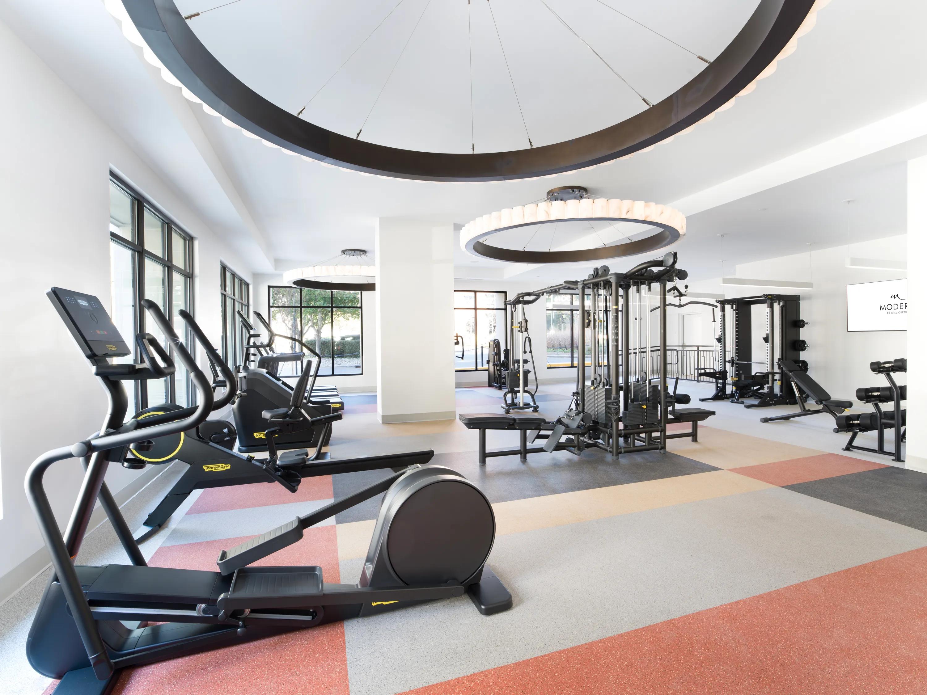 Fitness studio with spin bikes and golf simulator lounge modera liberty row apartments in charlotte nc