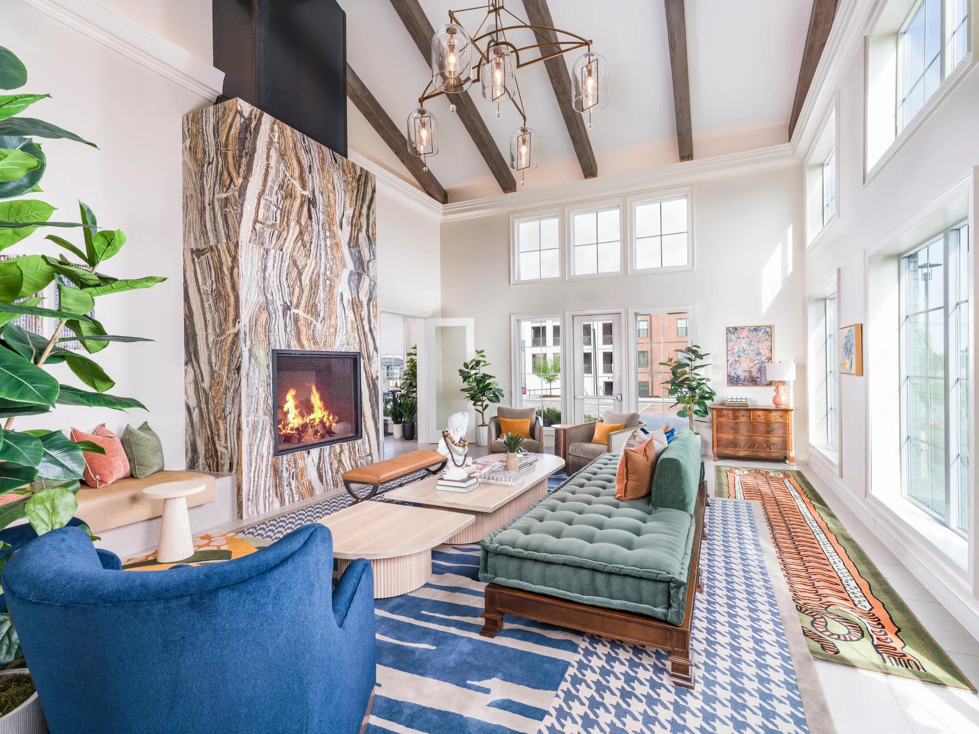 clubroom with large fireplace and seating areas with natural light modera mckinney ridge apartment homes for rent in tx