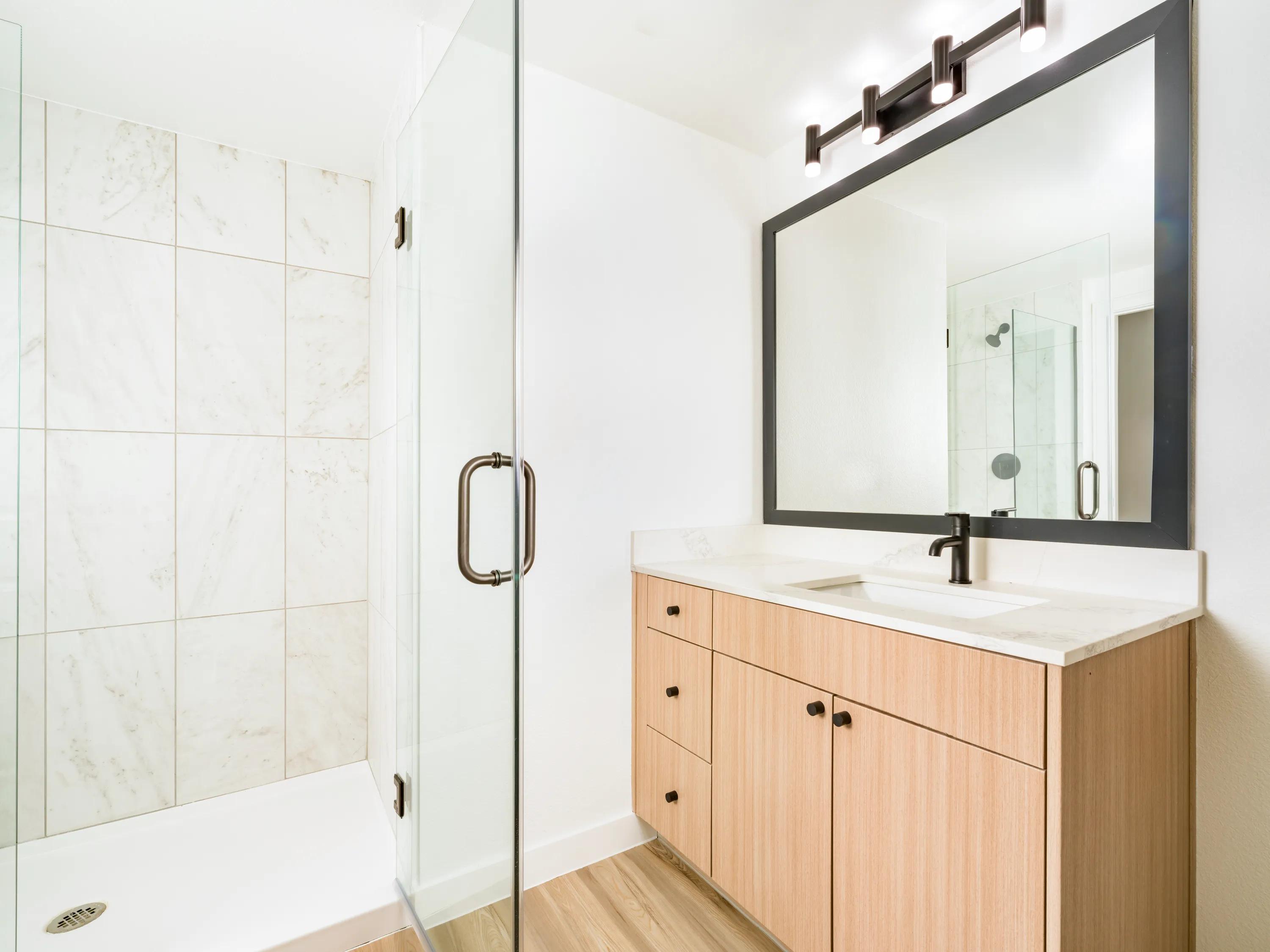 Premium finish bathroom with a glass-enclosed shower modera rio salado apartment homes for rent in tempe az