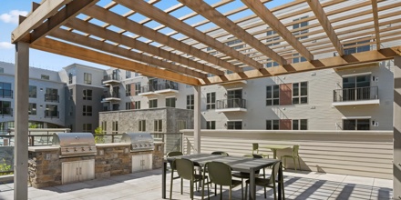 outdoor covered courtyard with bbq and dining table modera newton apartment homes for rent in ma