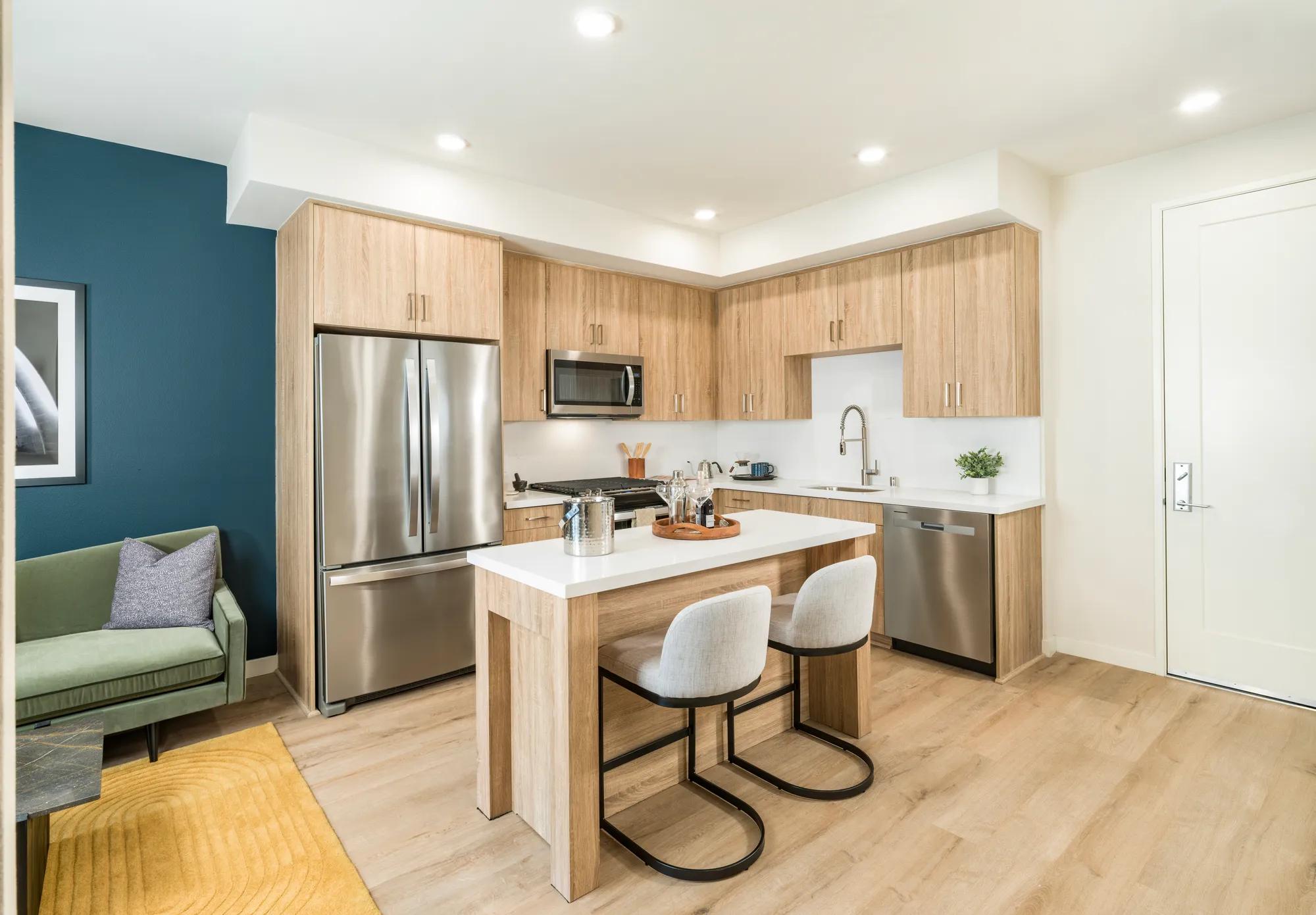 kitchen with granite countertops, island, stainless steel appliances, and more