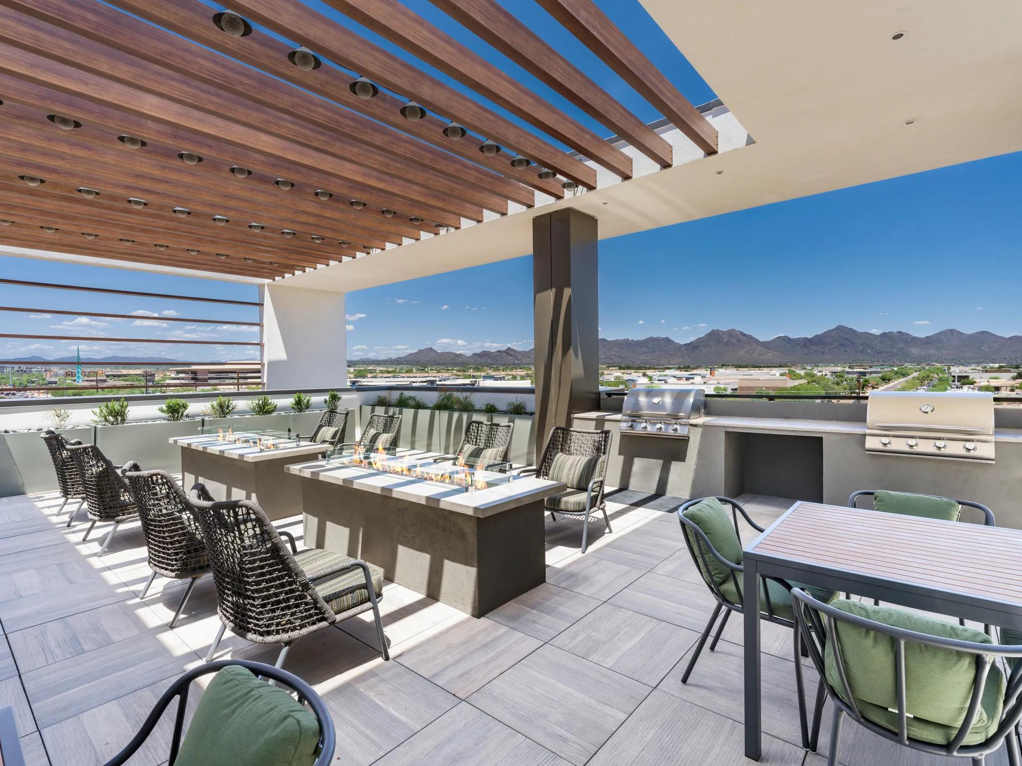 covered seating area with mountain views on rooftop with bbq grills at modera scottsdale apartment homes for rent in scottsdale az
