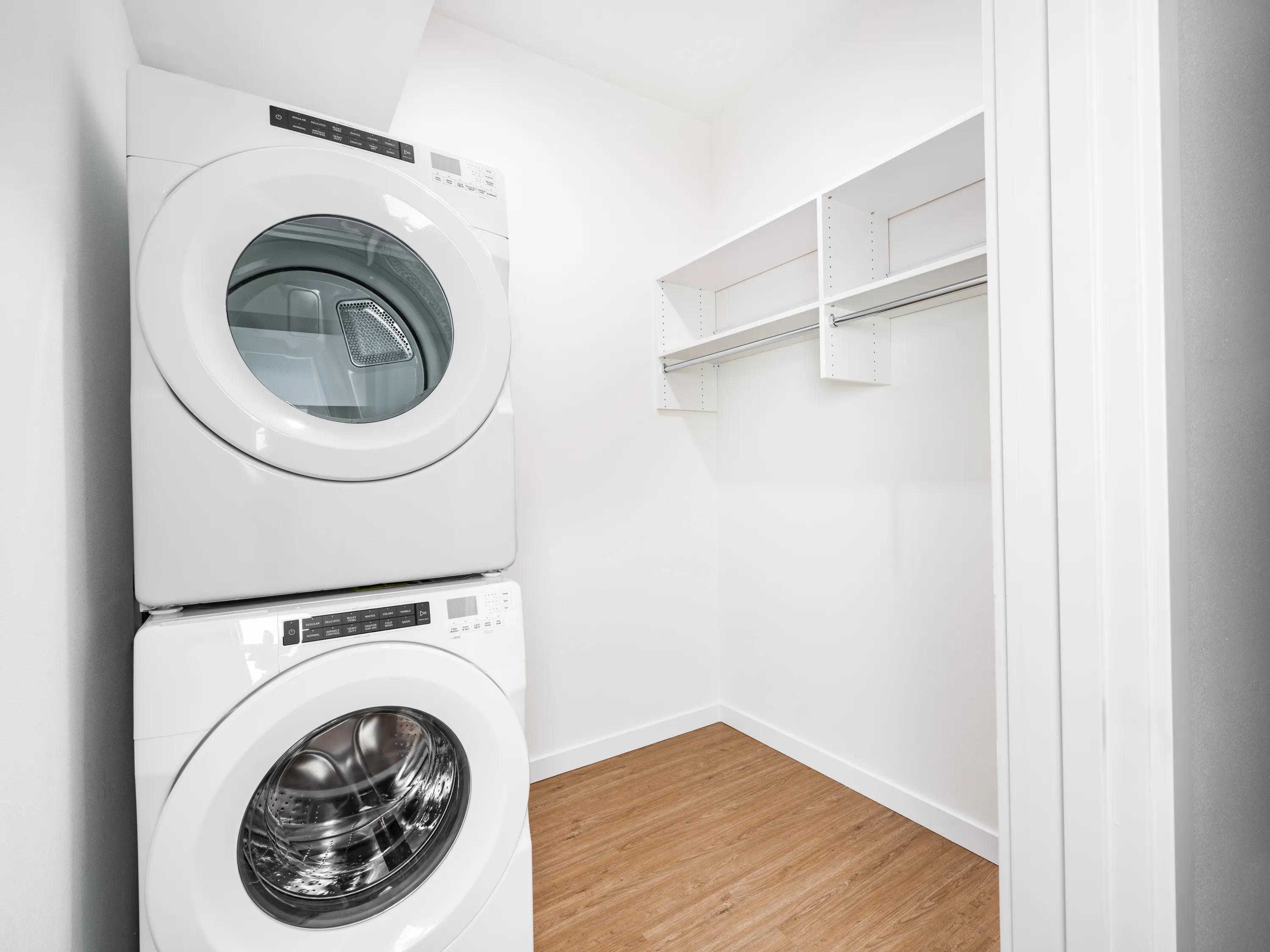 washer and dryer in laundry room with storage modera bridle trails apartment homes for rent