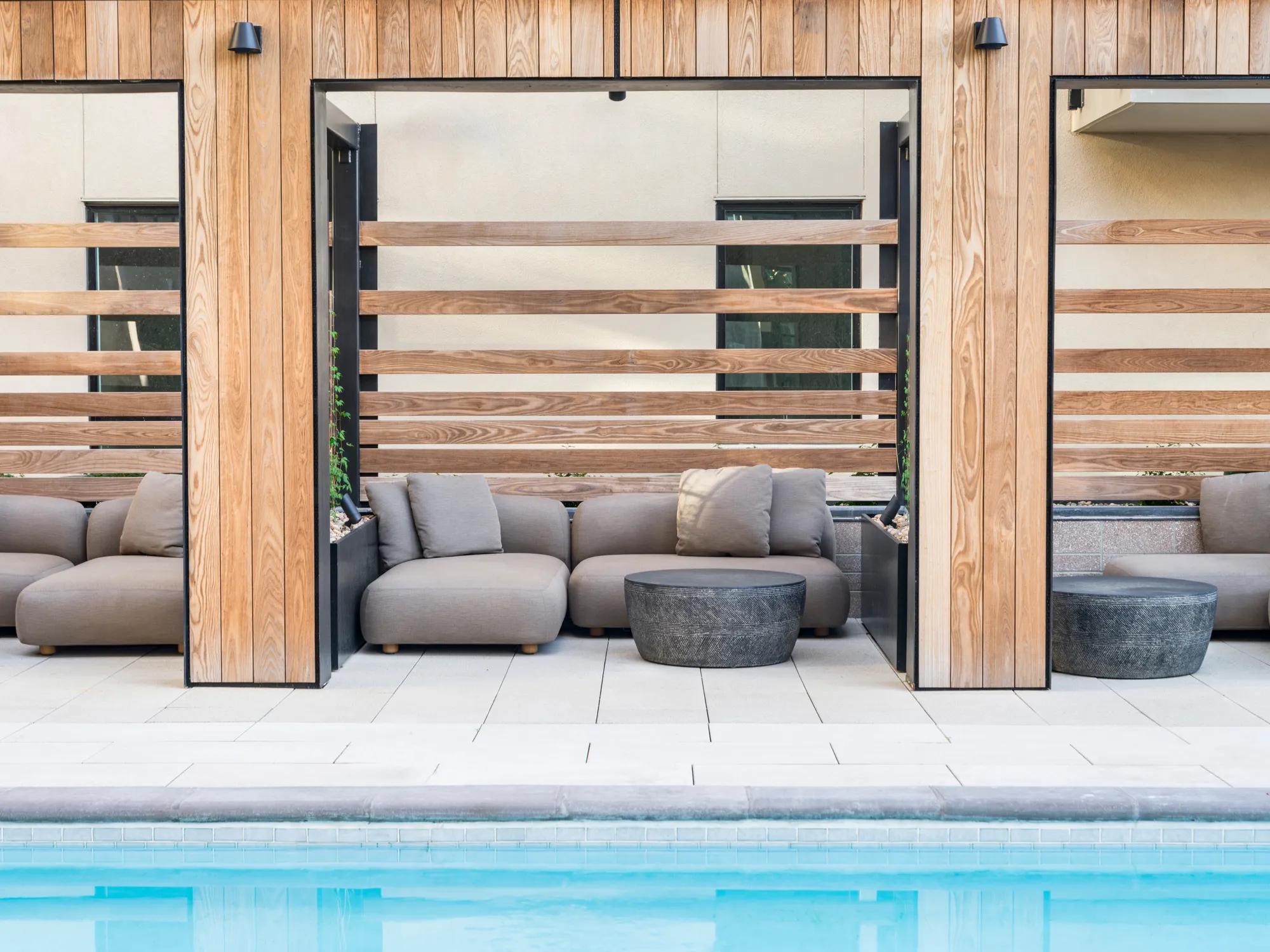 pool area leading to cabana lounge furniture with small coffee table modera golden triangle apartment homes for rent in denver co