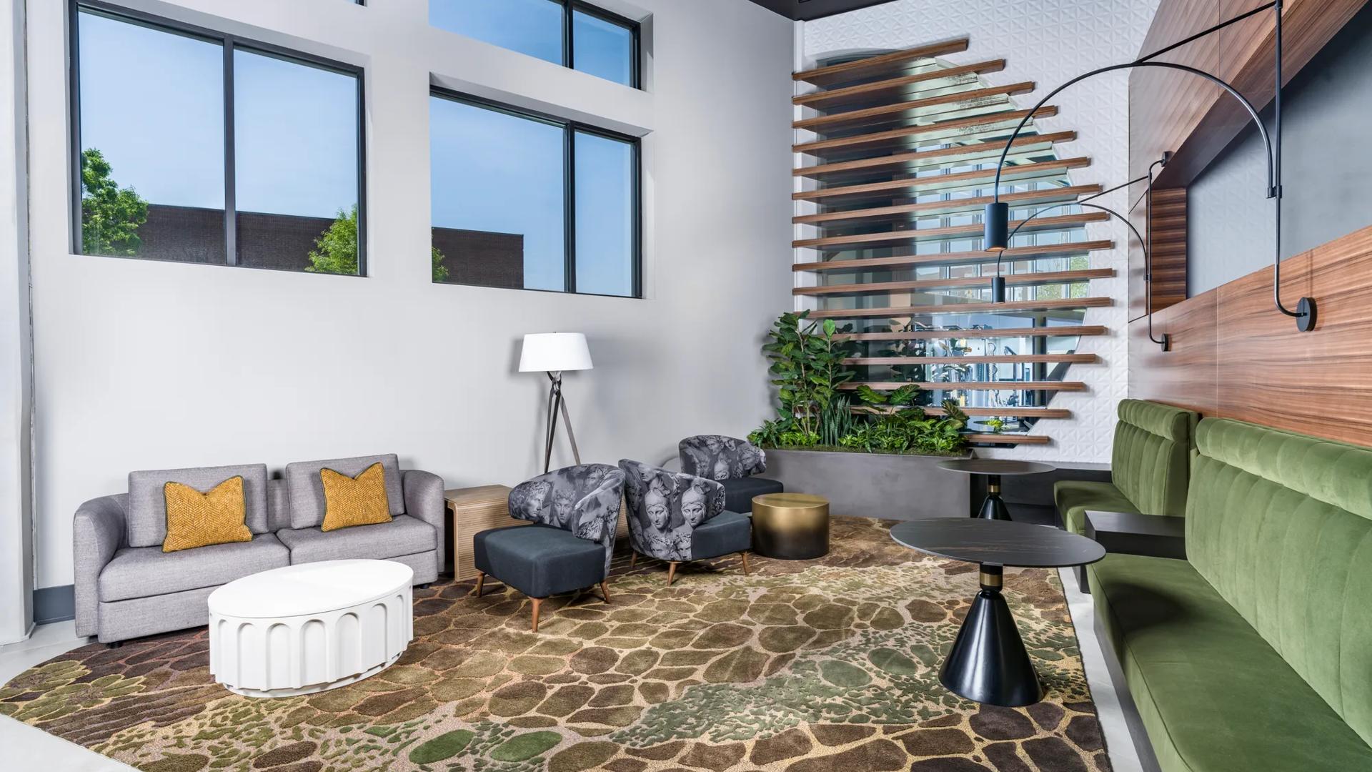 clubroom with large windows and fireplace with seating modera h street apartment homes for rent in washington dc