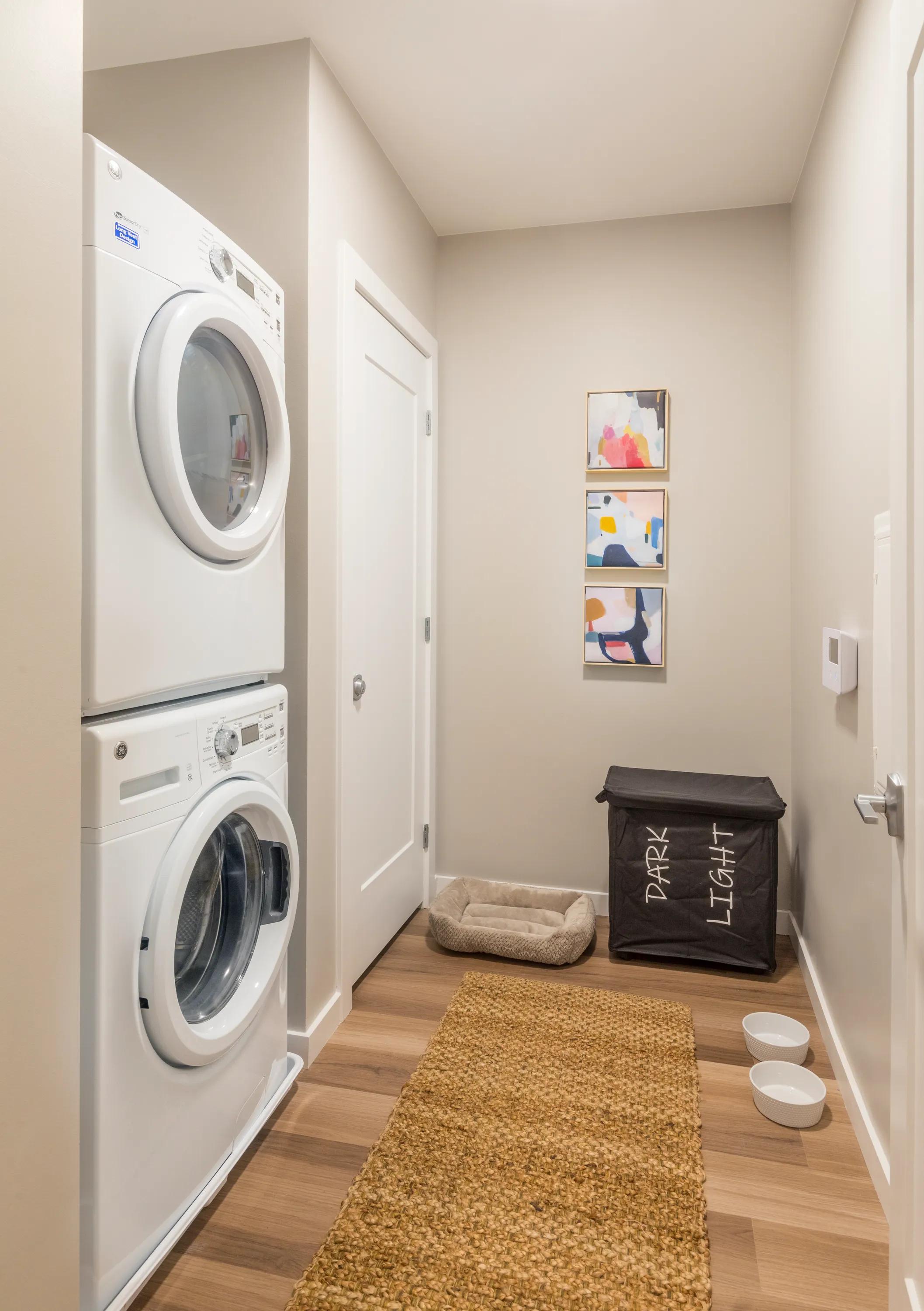 View of hallway featuring a Full-size front loading washers and dryers modera lohi apartments in denver co